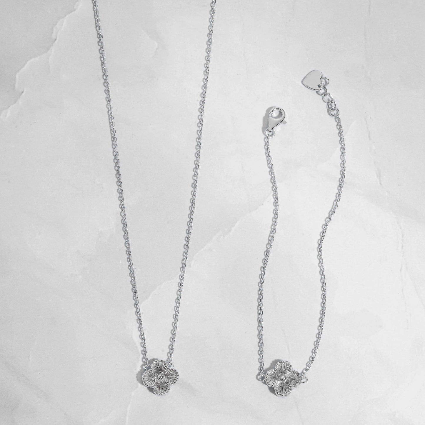 close up photo of silver four leaf clover necklace that can be matched with the clover bracelet.
