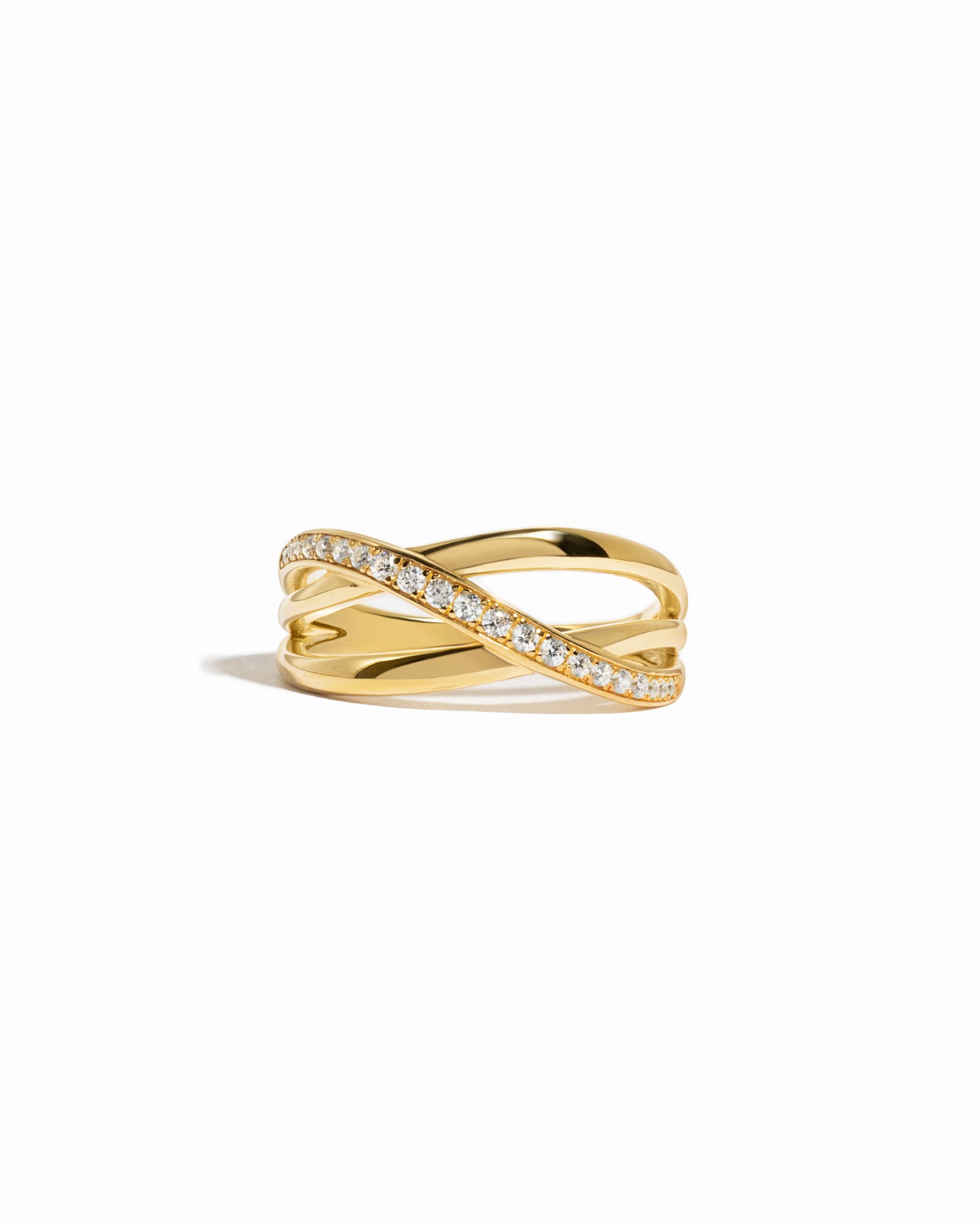 Gold ring with a double band and diamond accents on a white background