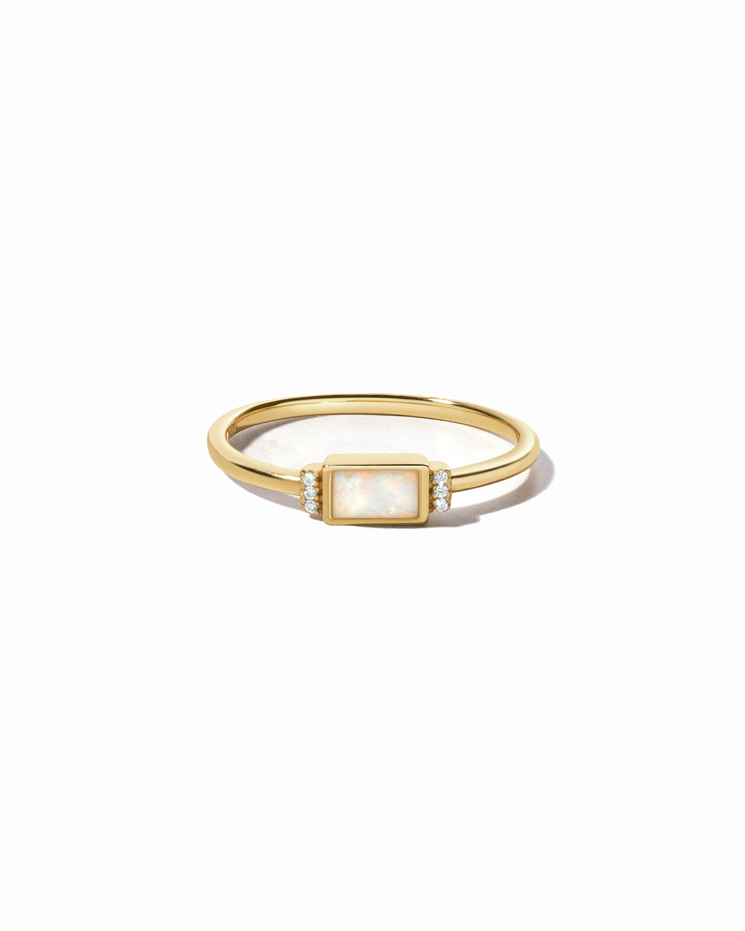 Gold opal baguette ring with side stones.