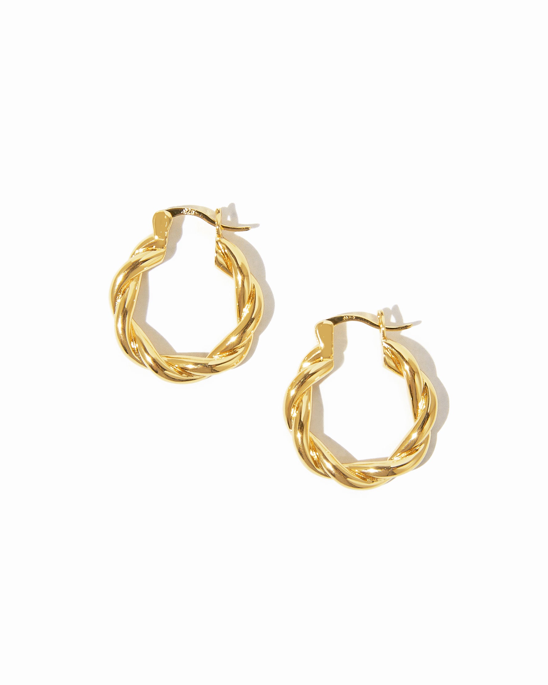 Gold chunky spiral hoop earrings.