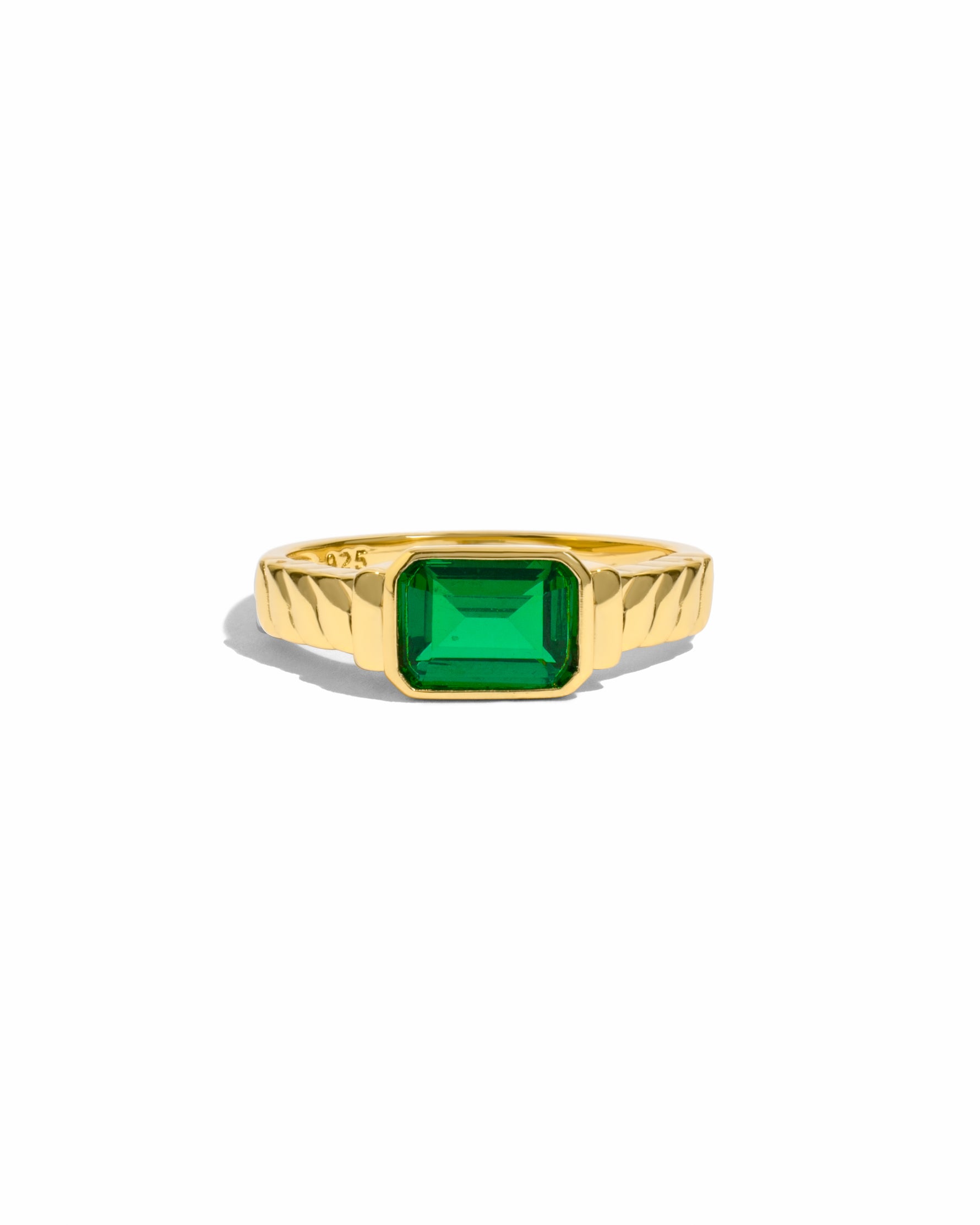 Statement gold ring with emerald gemstone.