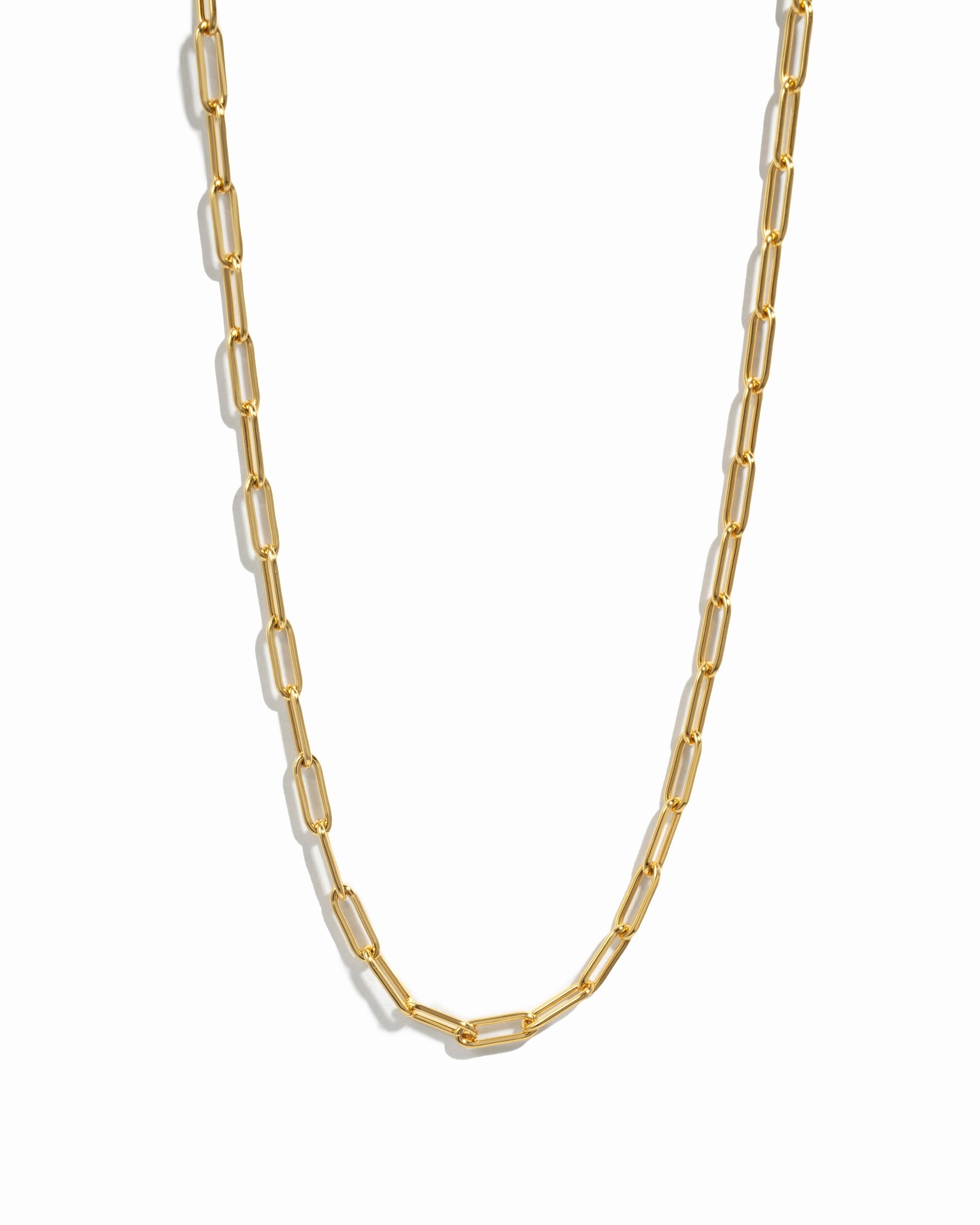 Versatile gold paperclip chain necklace on white background
