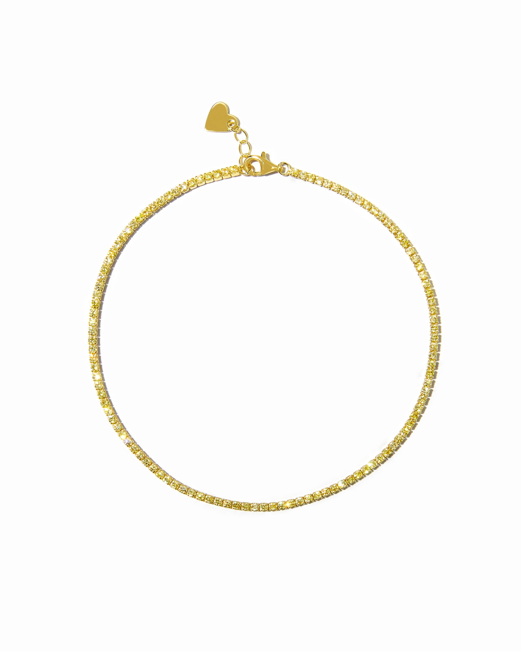 Gold yellow dainty tennis ankle bracelet on white background