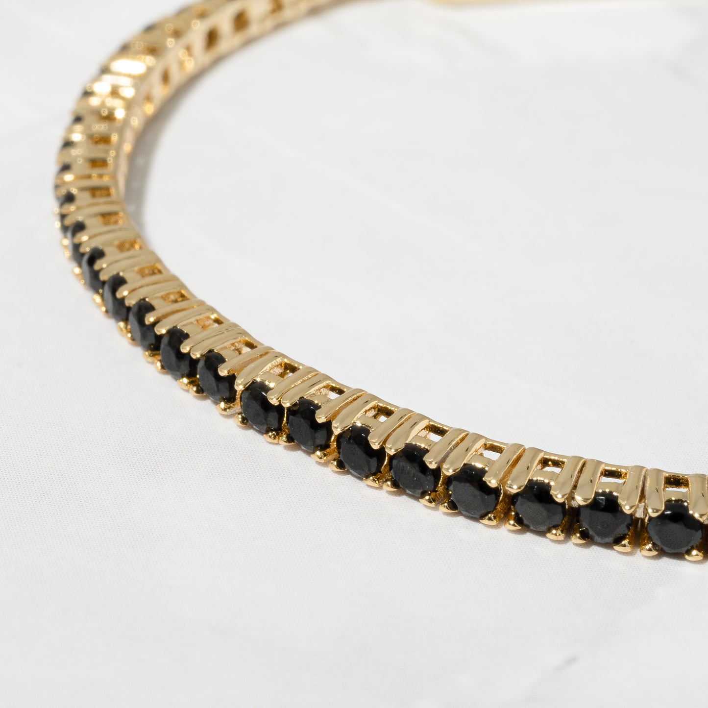 gold tennis bracelet with black stones