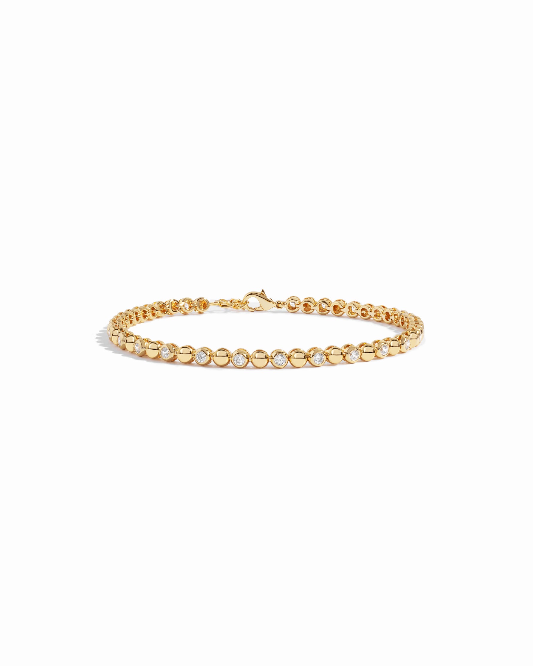 Gold bezel cz tennis bracelet on white background