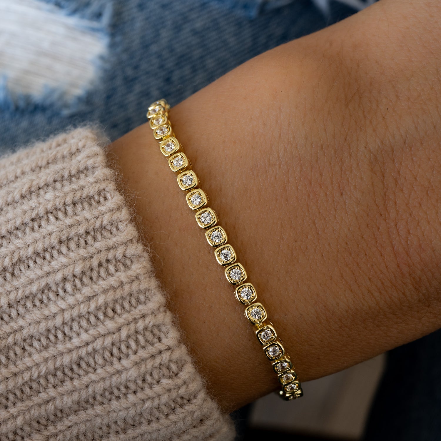 gold tennis bracelet on a model