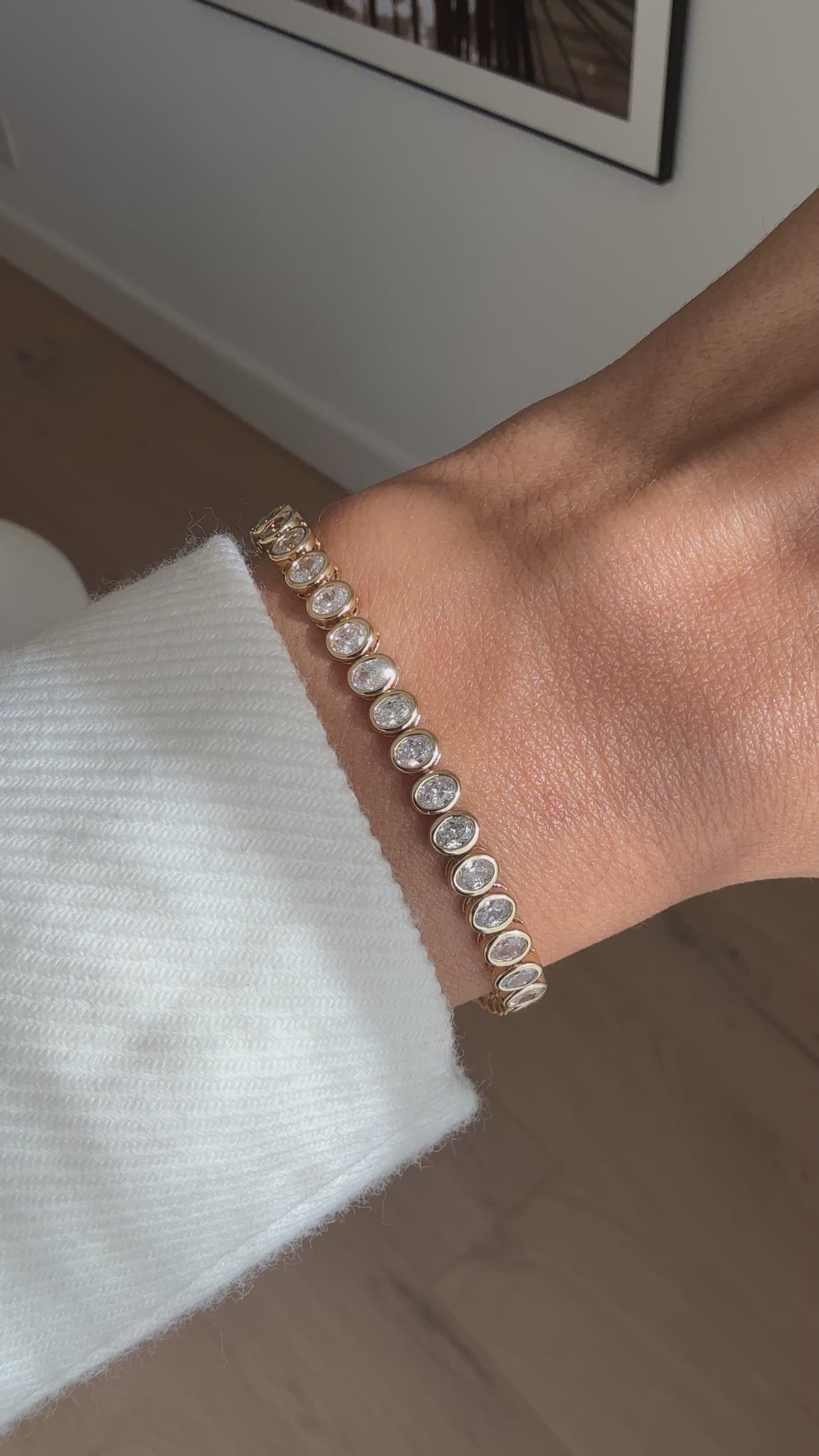 video of model wearing oval bezel tennis bracelet in gold