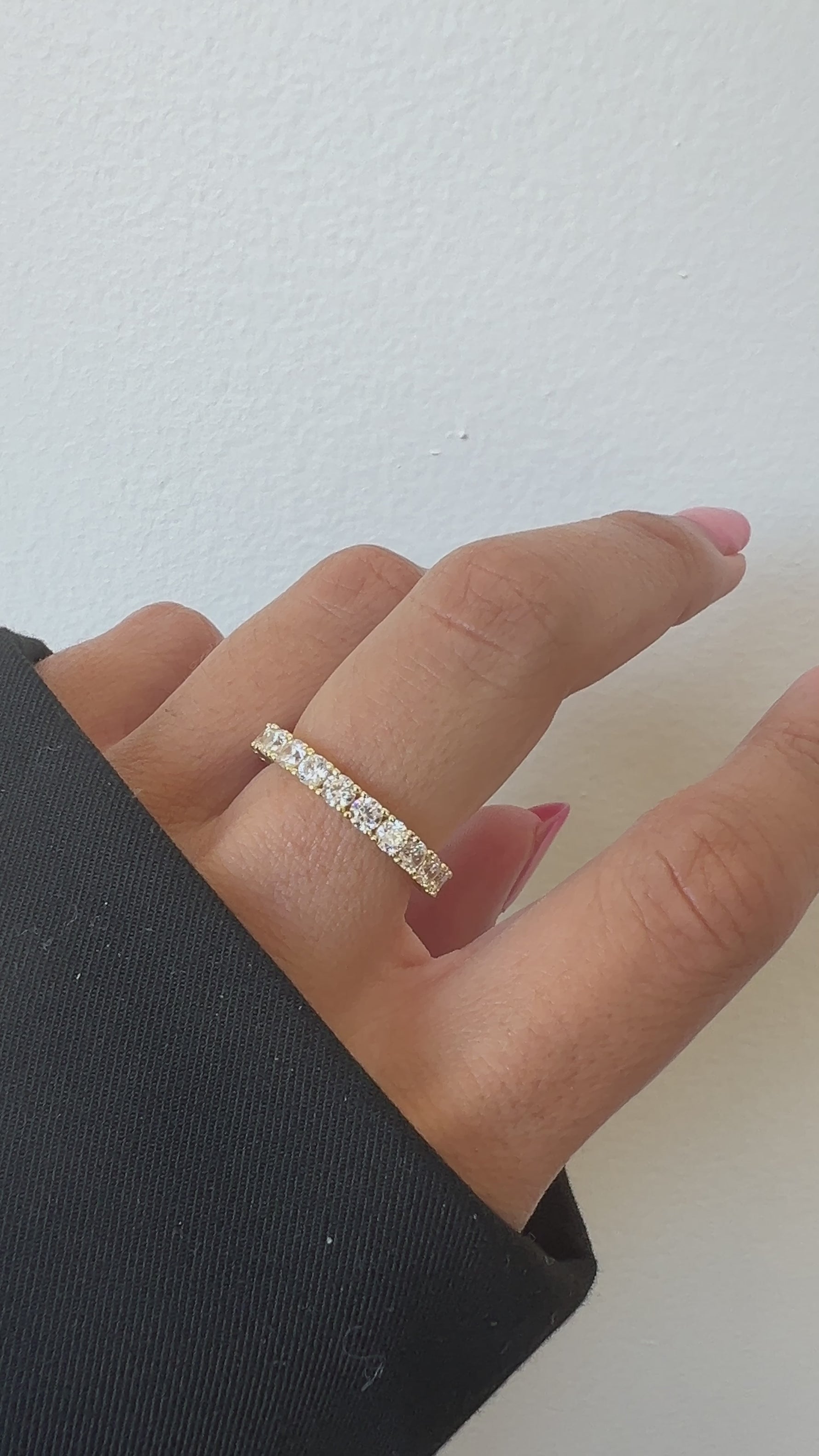 Video of model wearing statement diamond gold eternity ring.