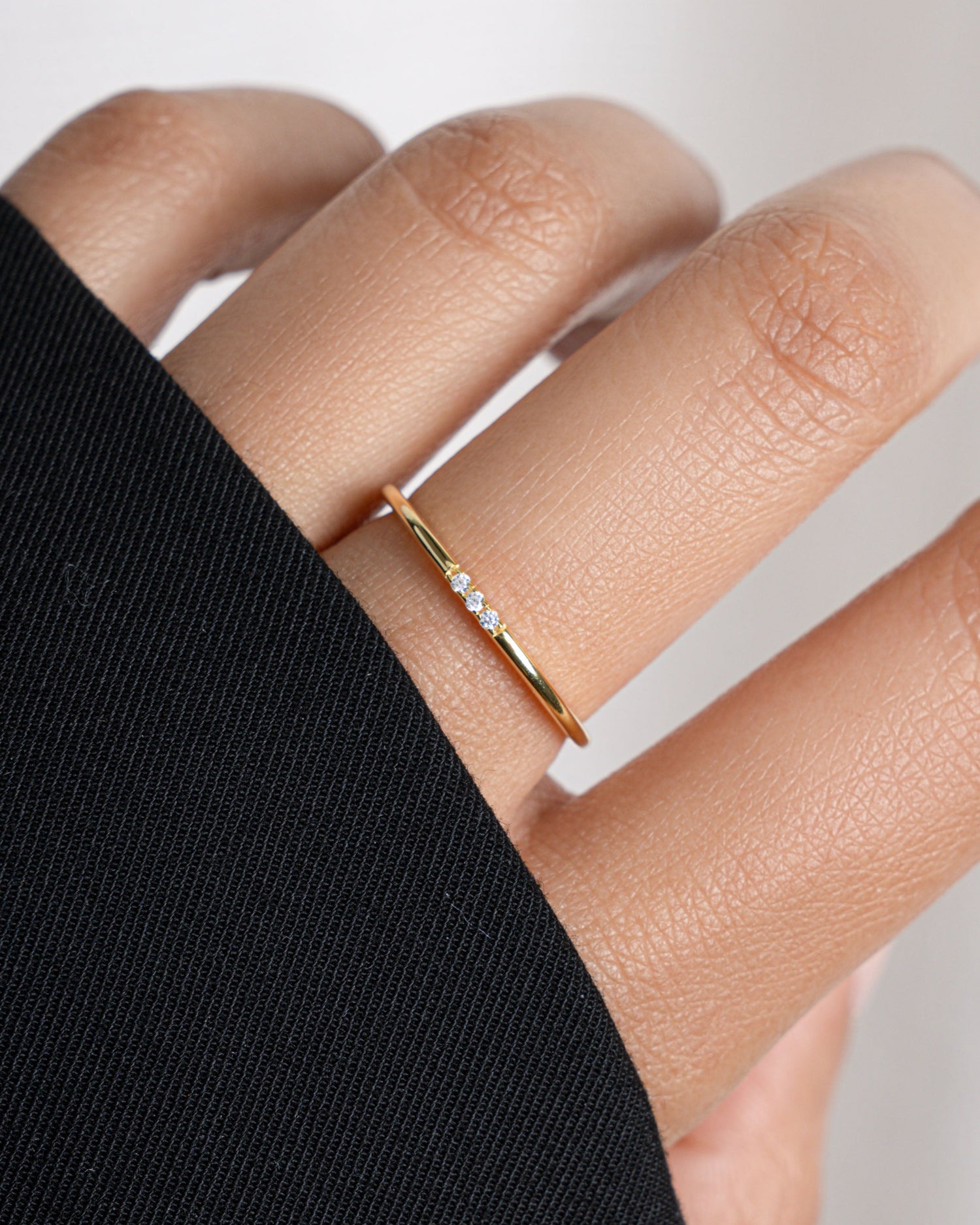 model wearing gold 3 stone cz ring