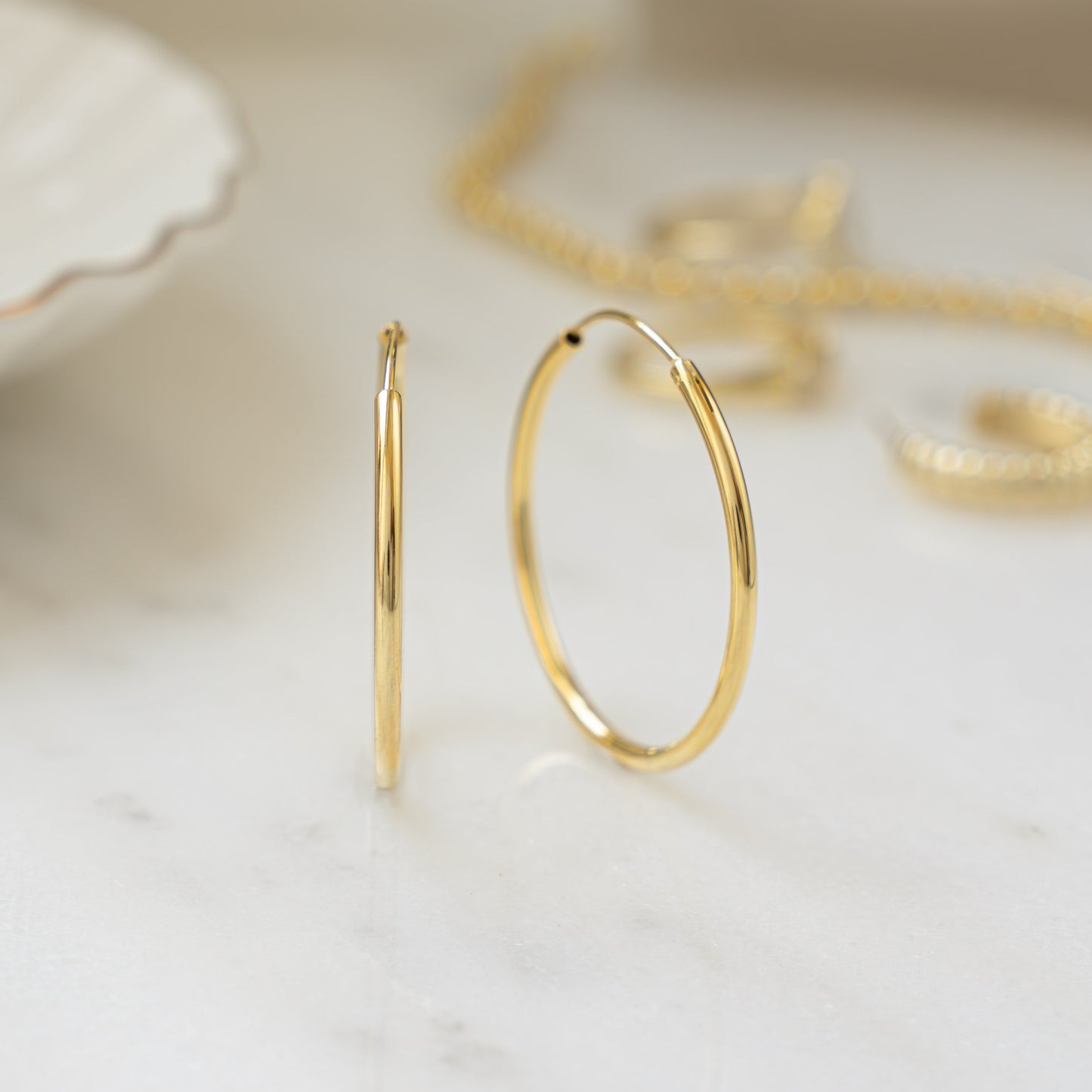 Closeup image of dainty minimalist hoop earrings