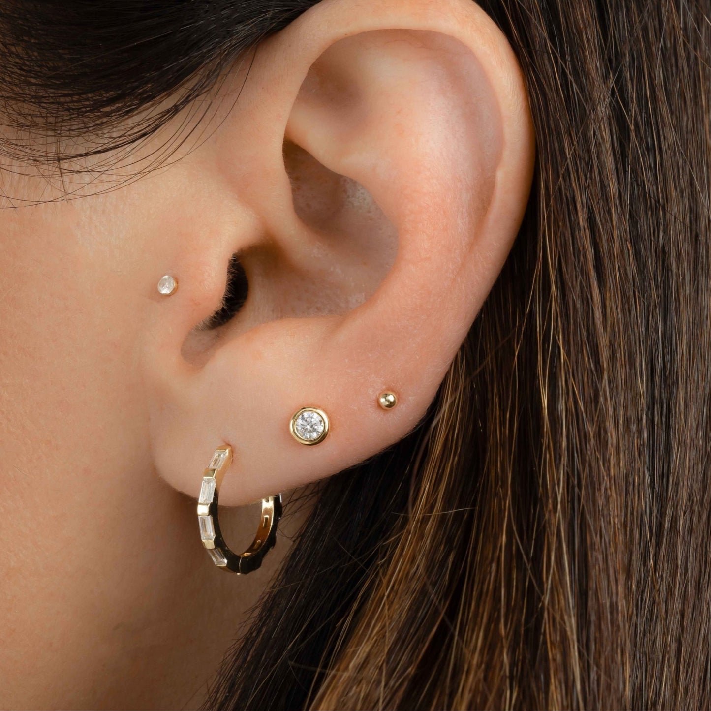 dainty earring stack featuring minimalist huggie hoop earrings with cubic zirconia diamonds