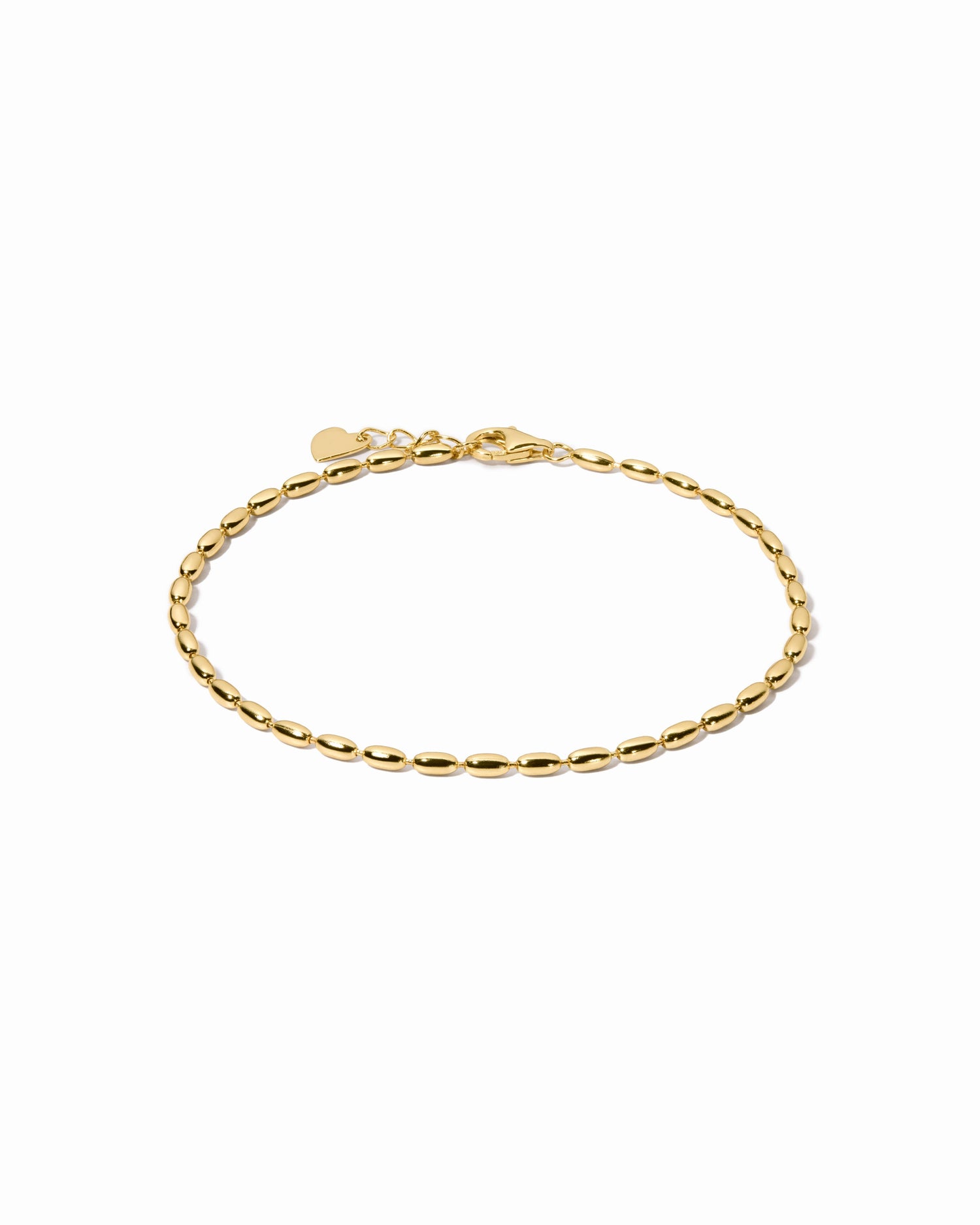 Gold beaded chain bracelet on white background