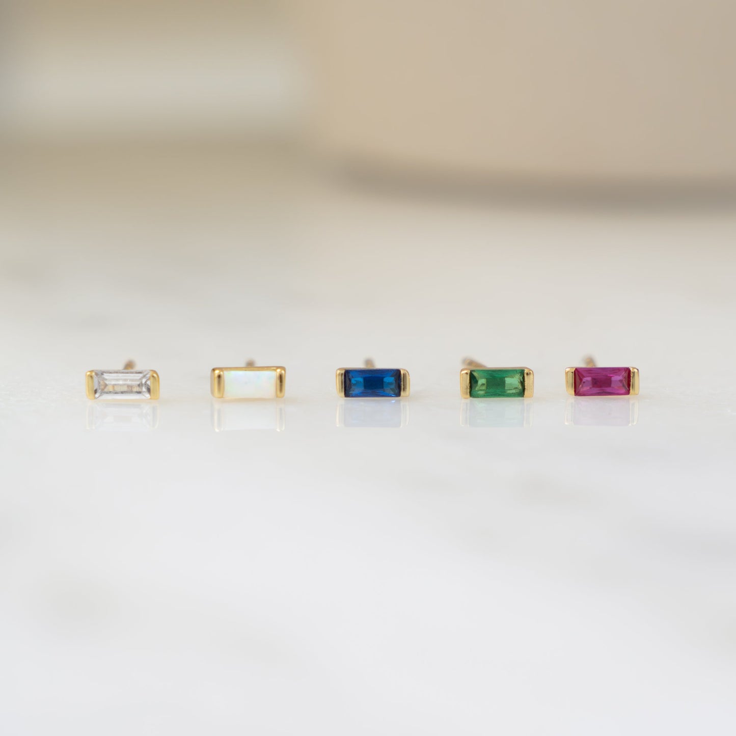 Closeup image of dainty gemstone tiny stud earrings