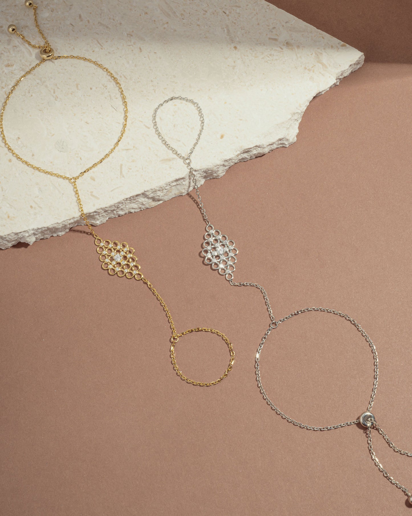 image of two chain bracelets featuring a gold ring bracelet, and a silver adjustable bracelet