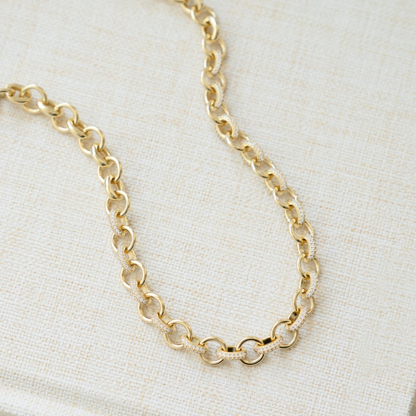 Closeup image of gold jewelry gift featuring chunky chain necklace