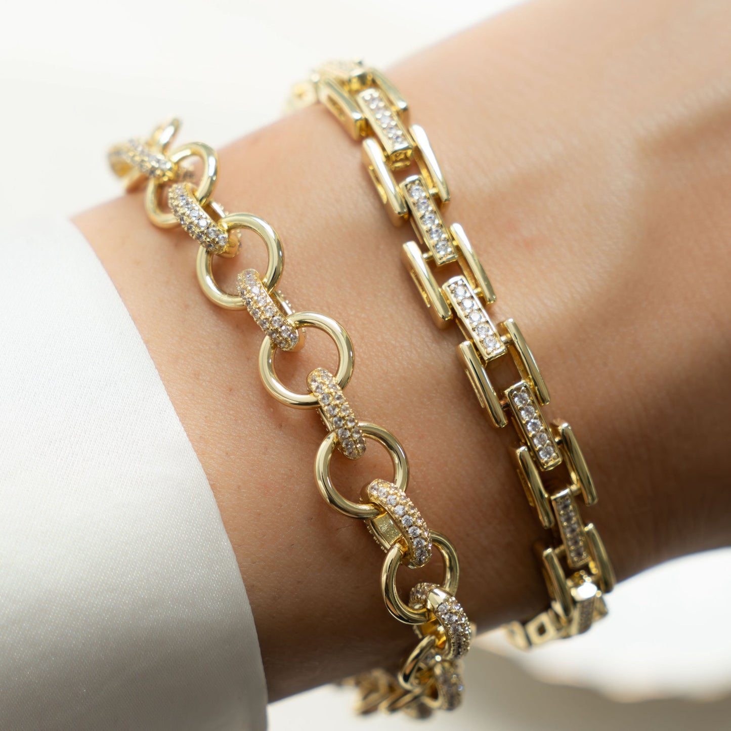 Model showing off gold jewelry featuring gold diamond chain link bracelet