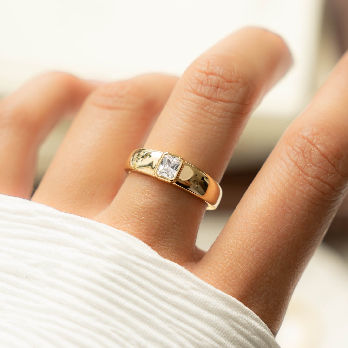 model wearing chunky gold dome ring