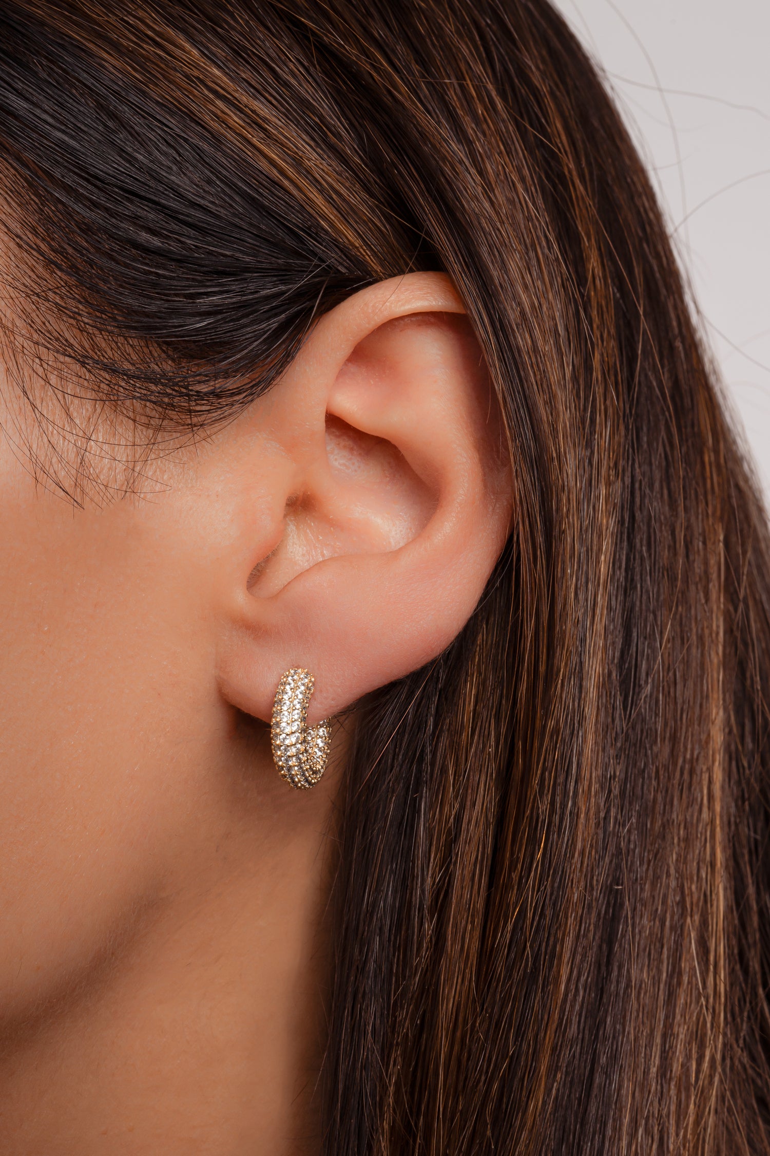Model wearing gorgeous gold pave diamond tube hoop earrings