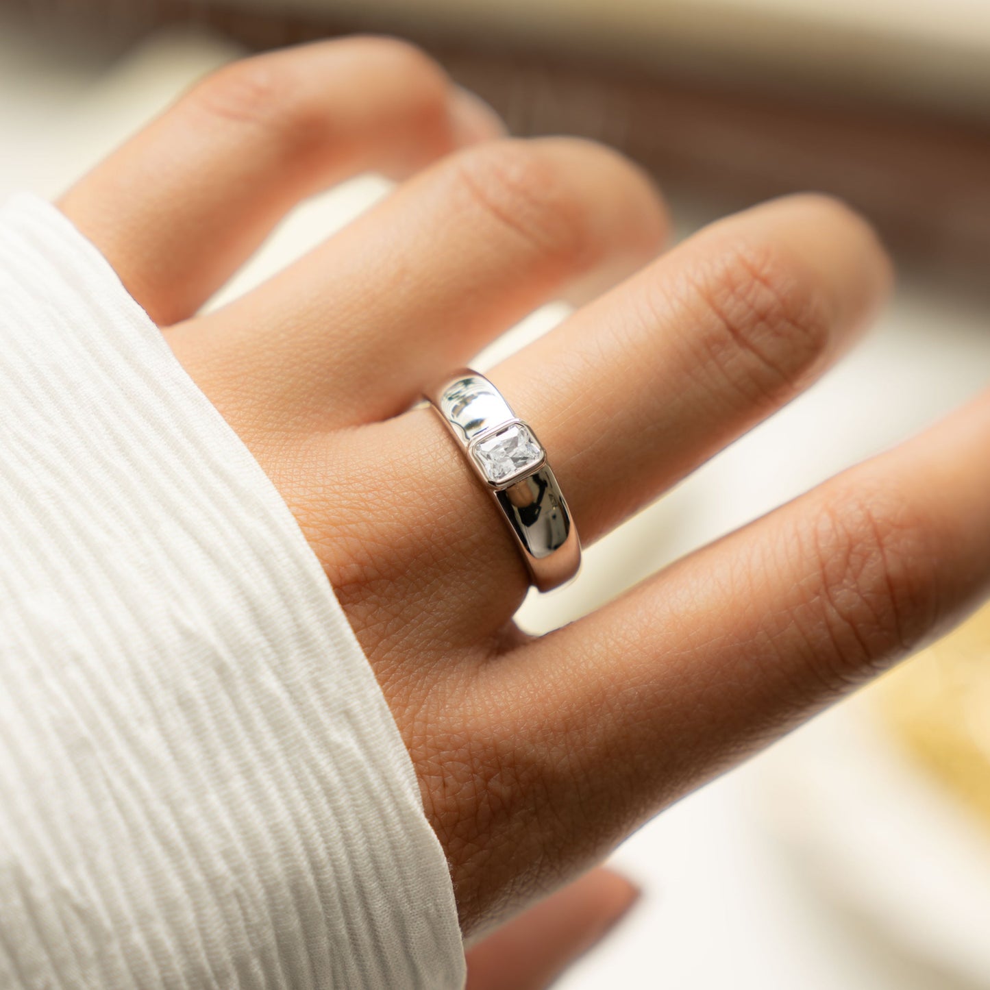 model wearing statement dome ring featuring silver baguette diamond