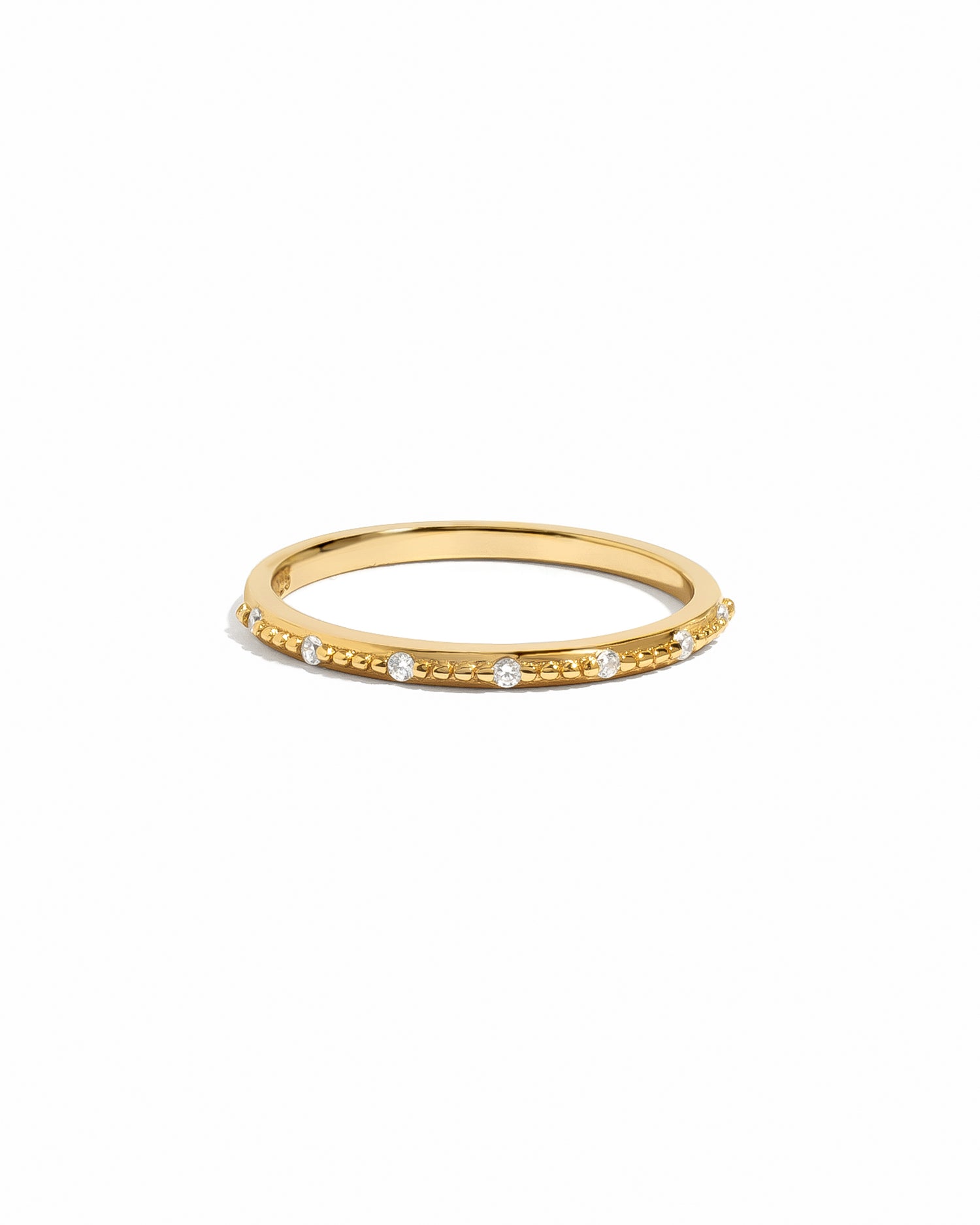 sami jewels gold stacking ring with cubic zirconia stones on a white background