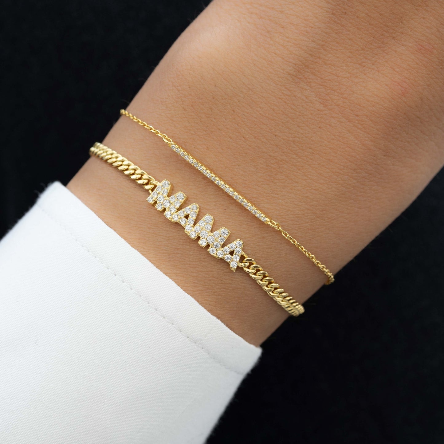 model wearing gold jewelry featuring diamond bracelet with gold MAMA chain on gold chain