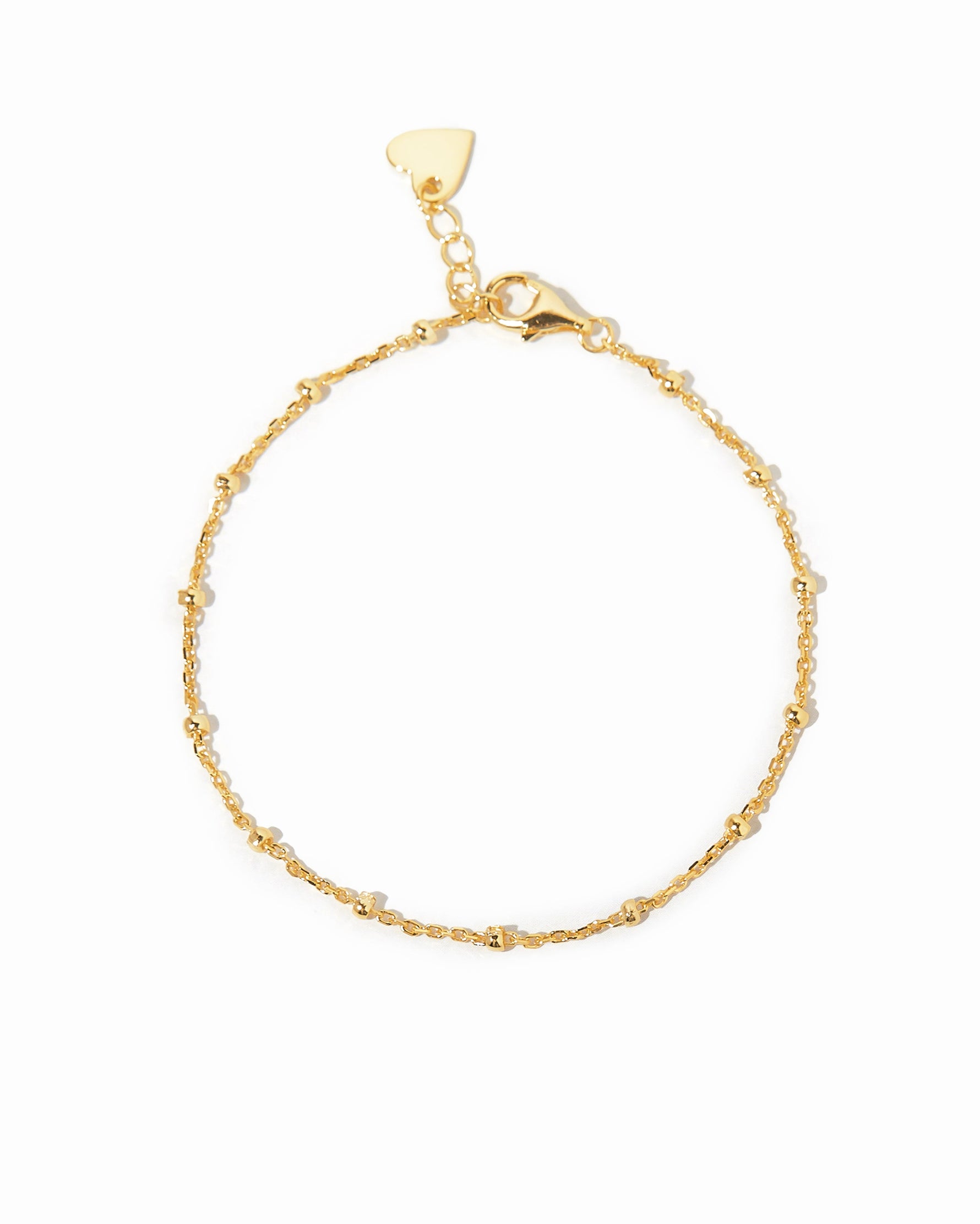 Gold beaded ankle bracelet on a white background