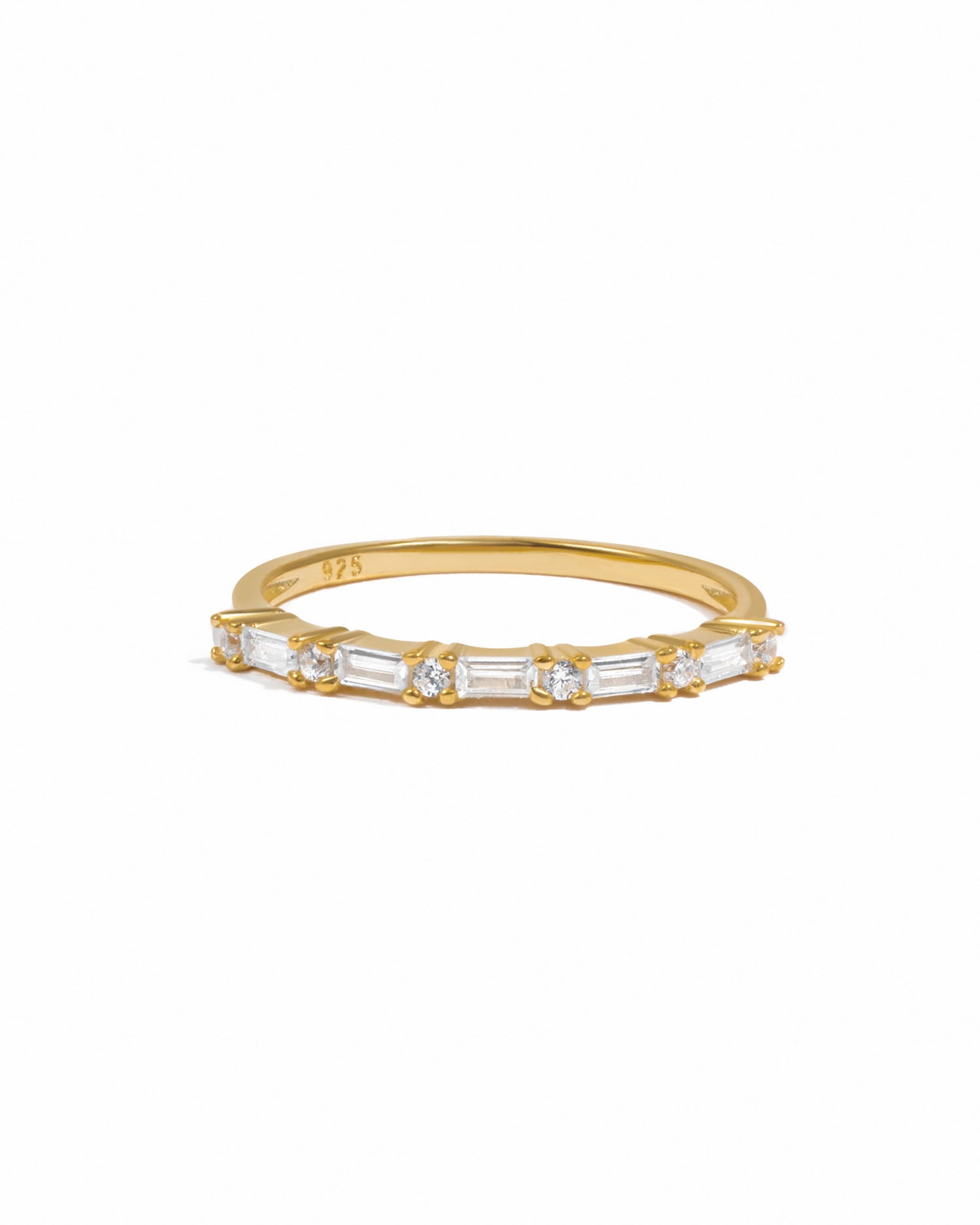 Gold ring with baguette diamonds on a white background