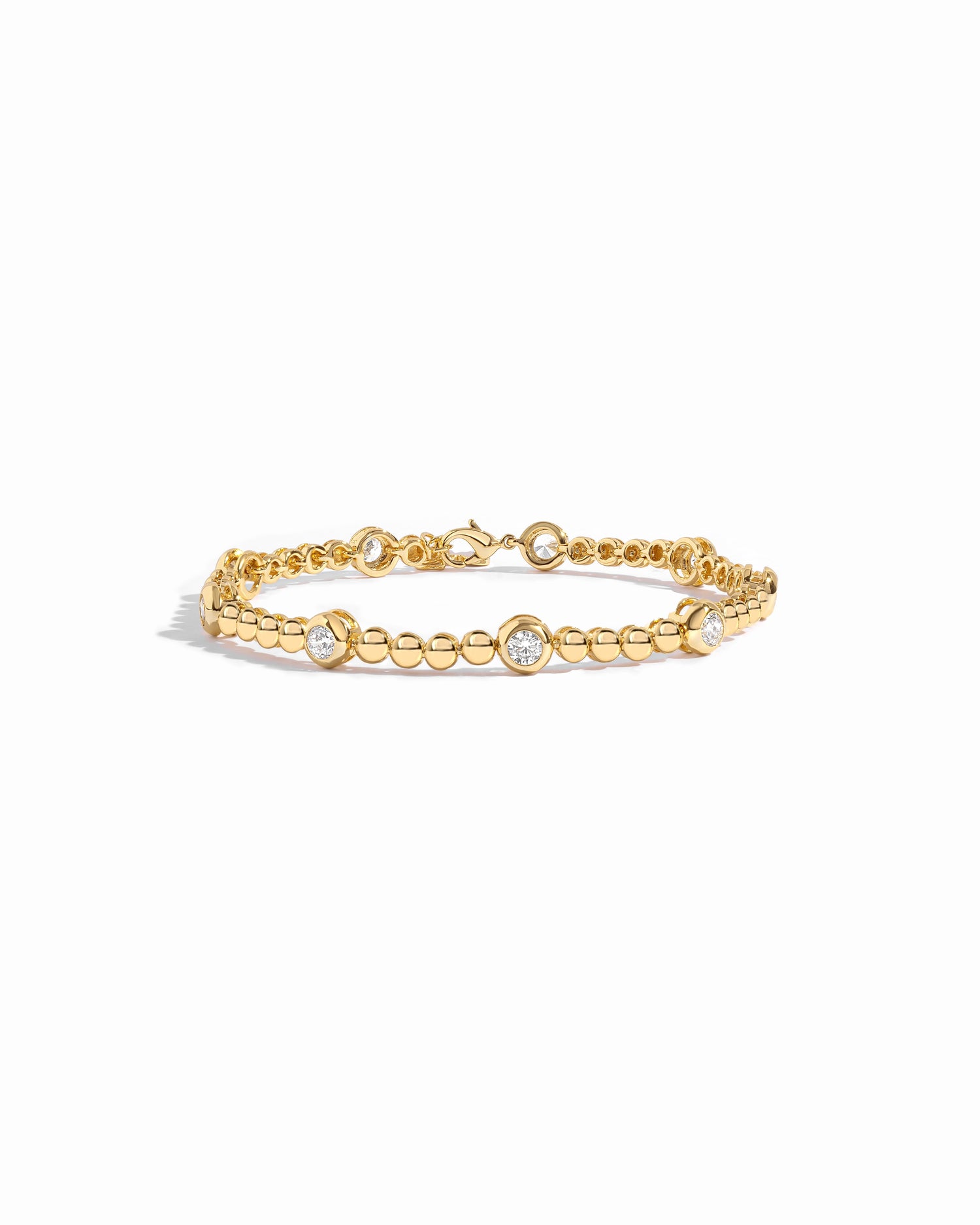 14k gold bracelet with small beads and large bezels.