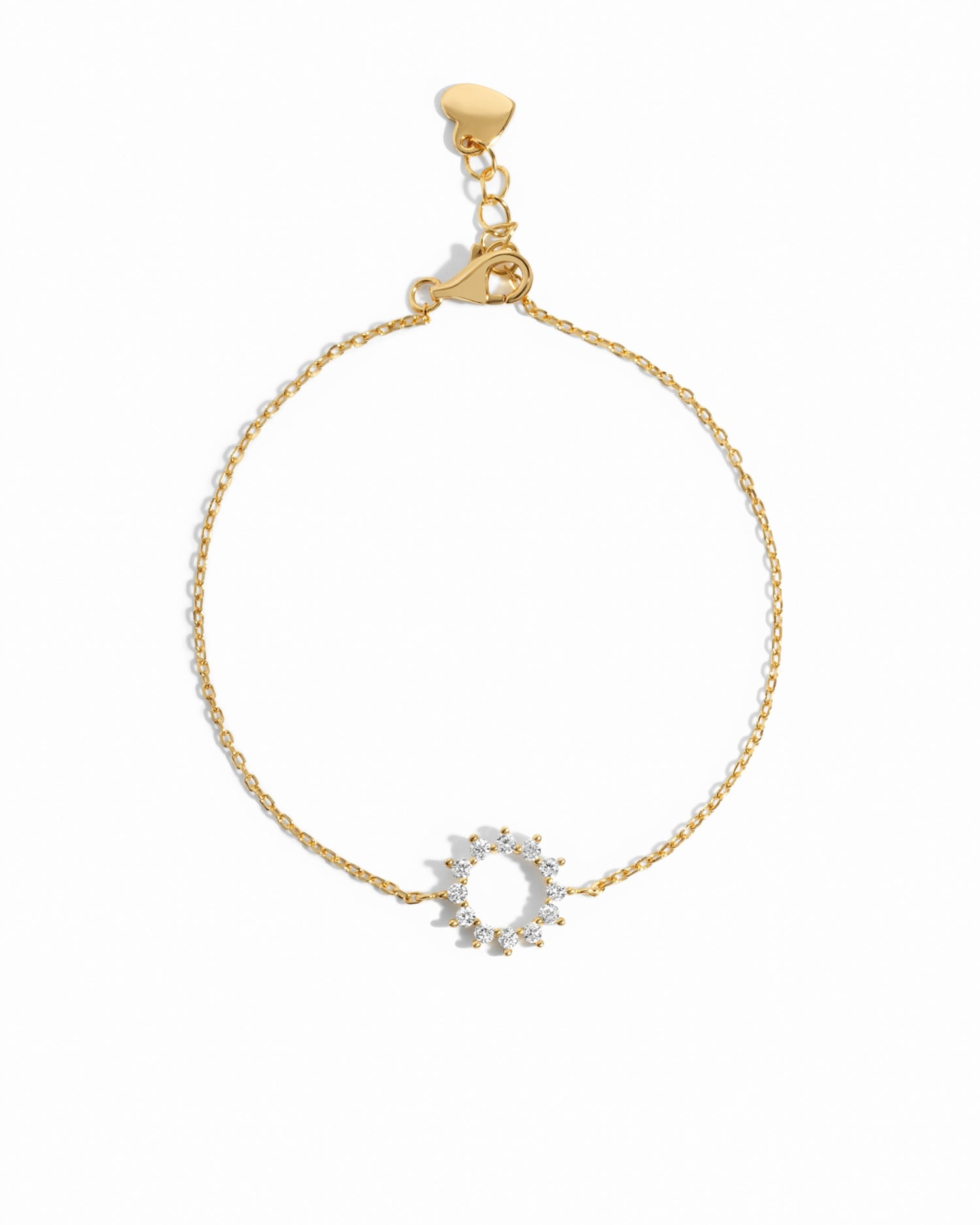 Gold sun charm bracelet on white background