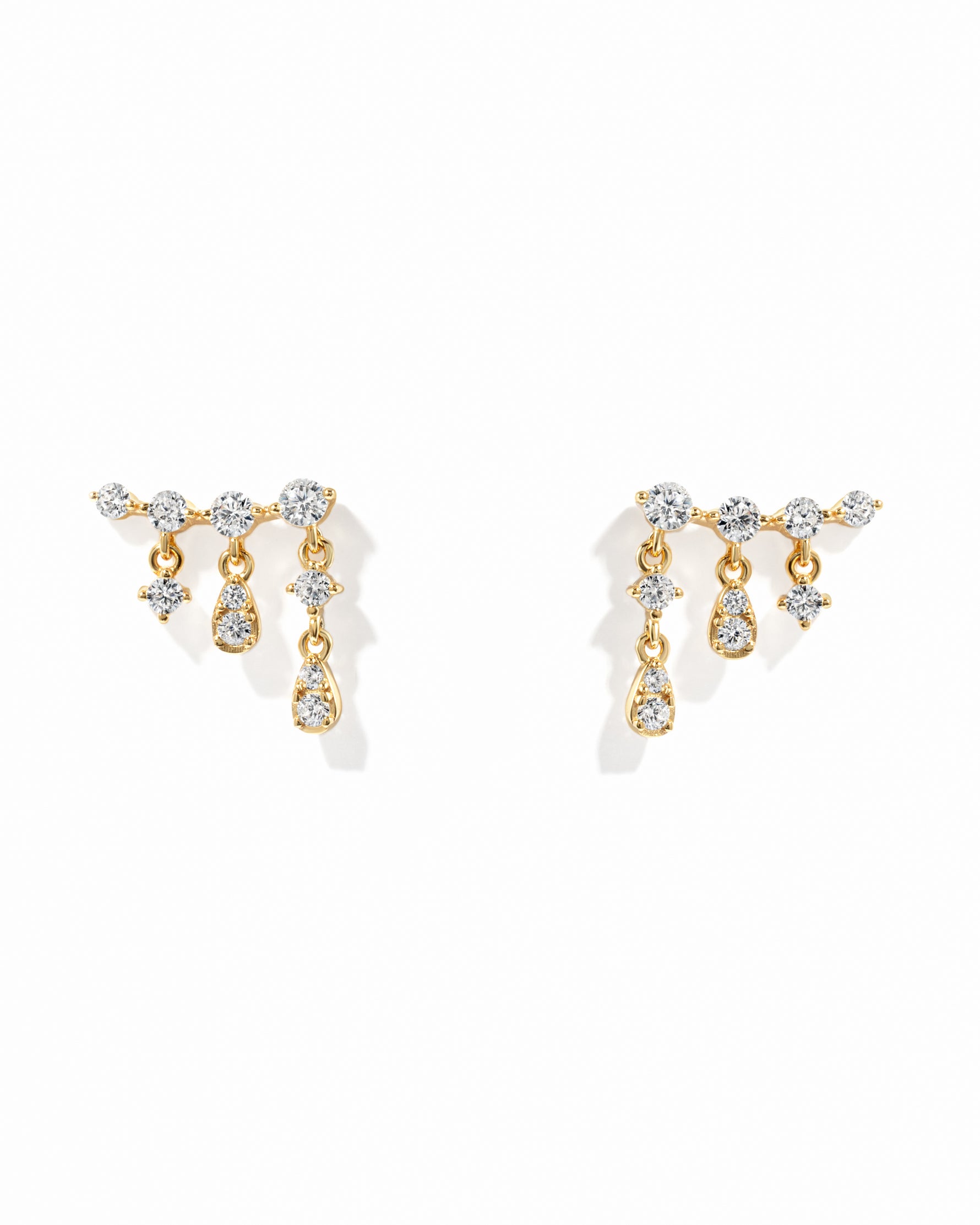 Gold ear climber earring on a white background