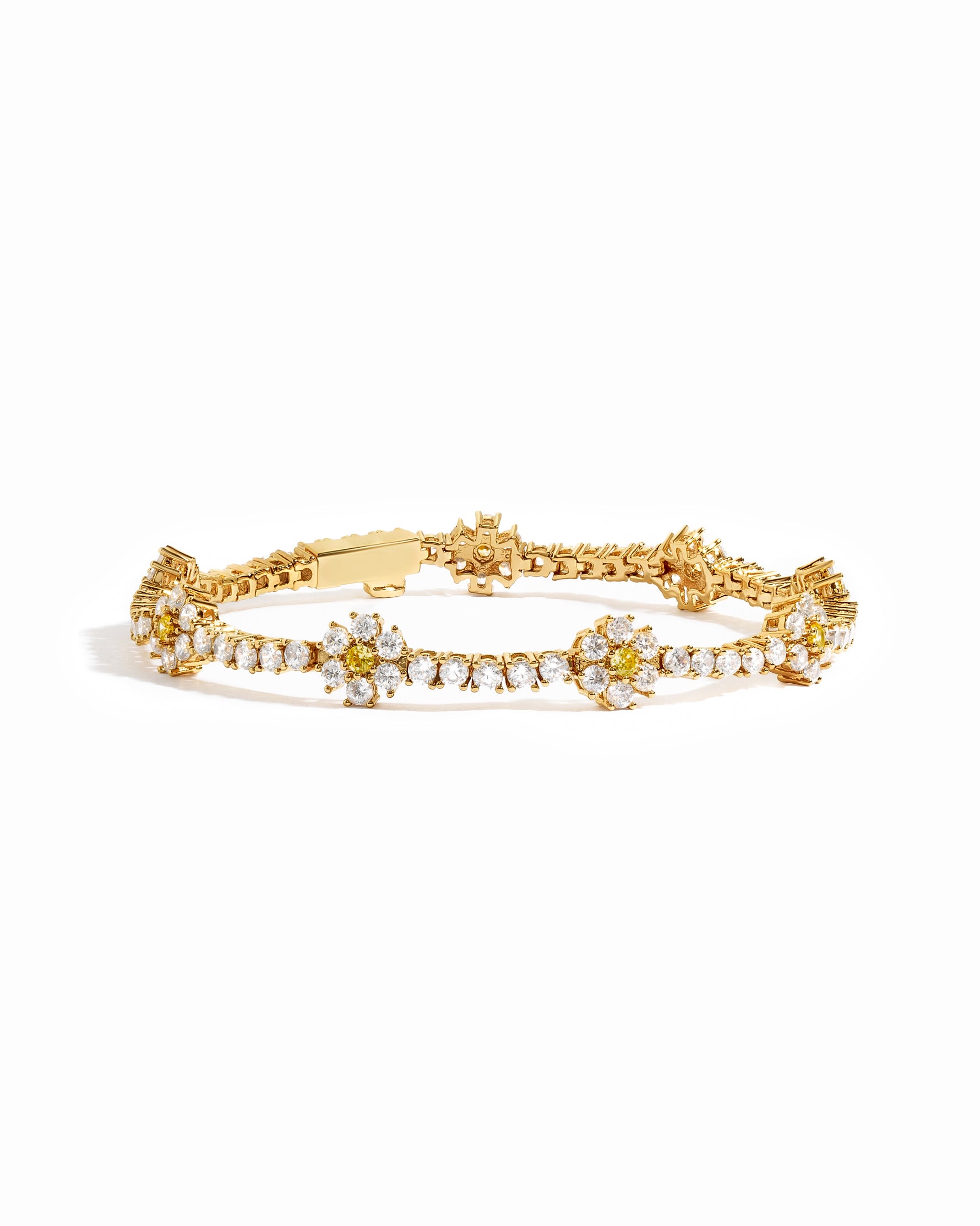 Gold bracelet with floral design on a white background