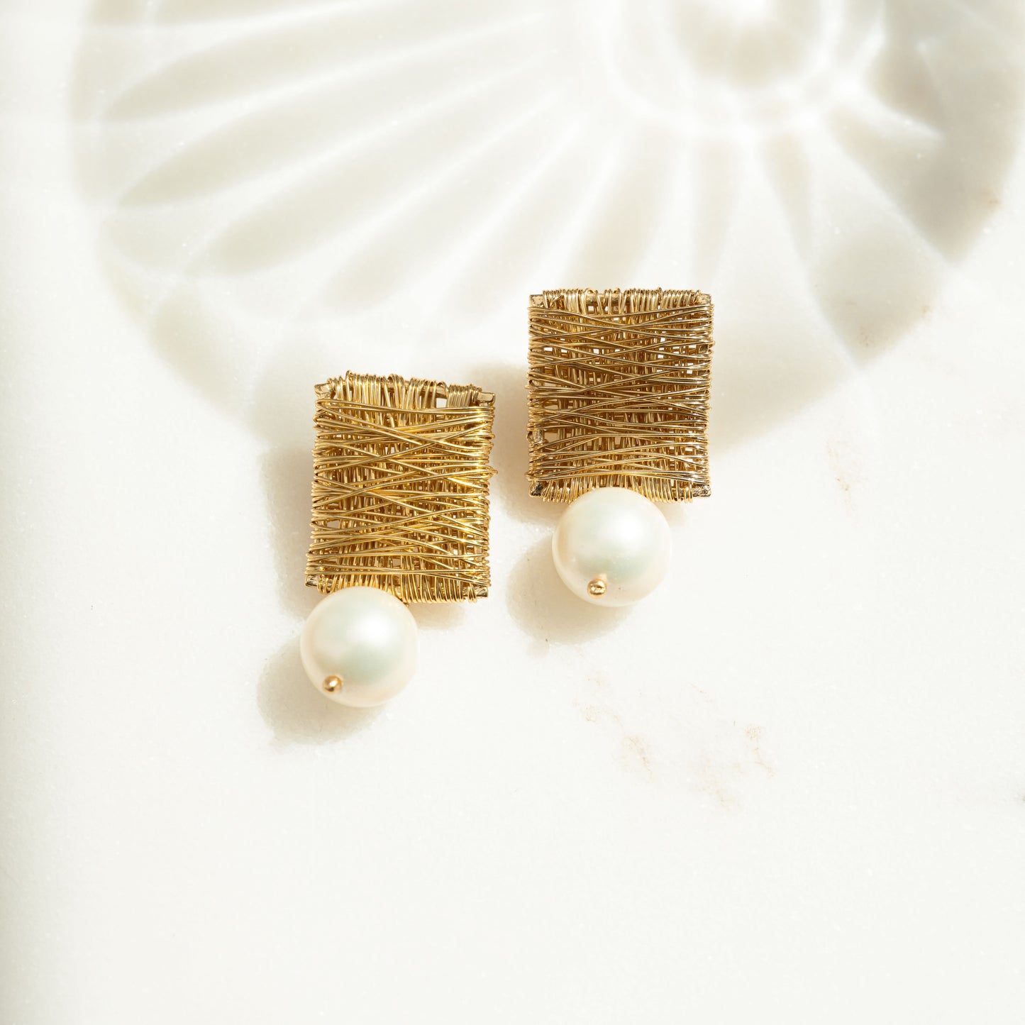 closeup image of pearl dangle drop statement earrings