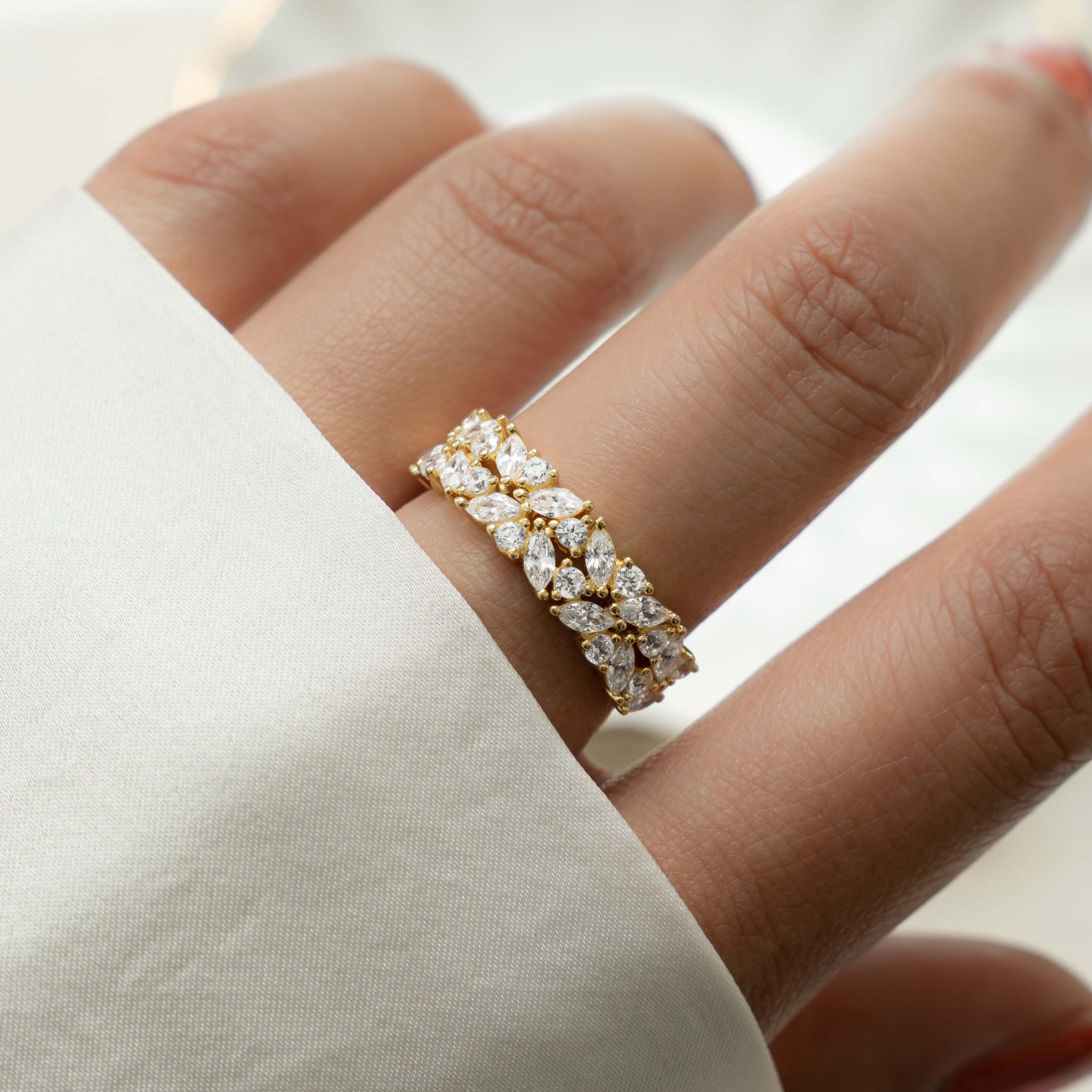 Gold double cluster ring with diamond accents by Sami Jewels, showcasing intricate design and sparkling gemstones.