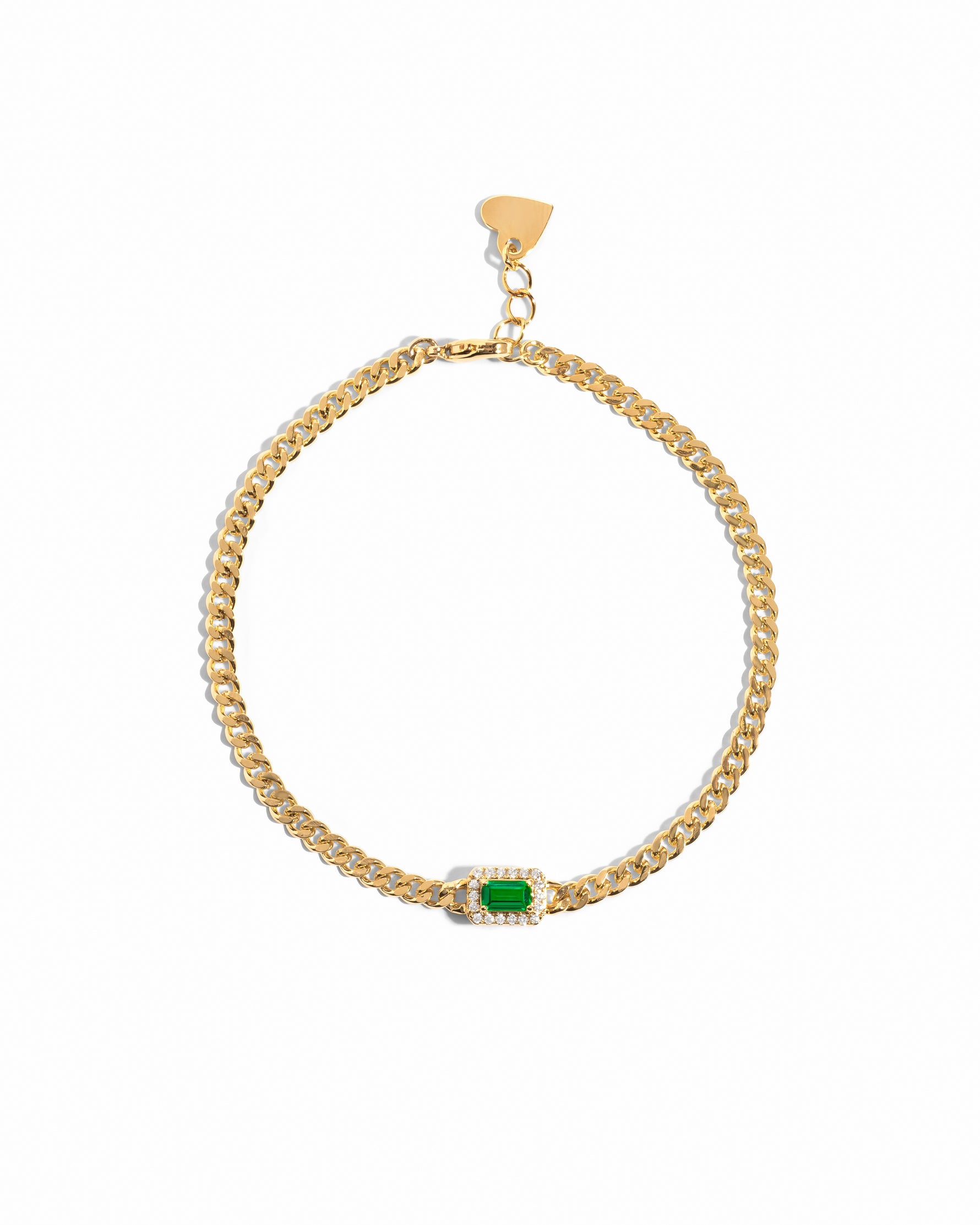 Gold bracelet with a emerald green gemstone on a white background