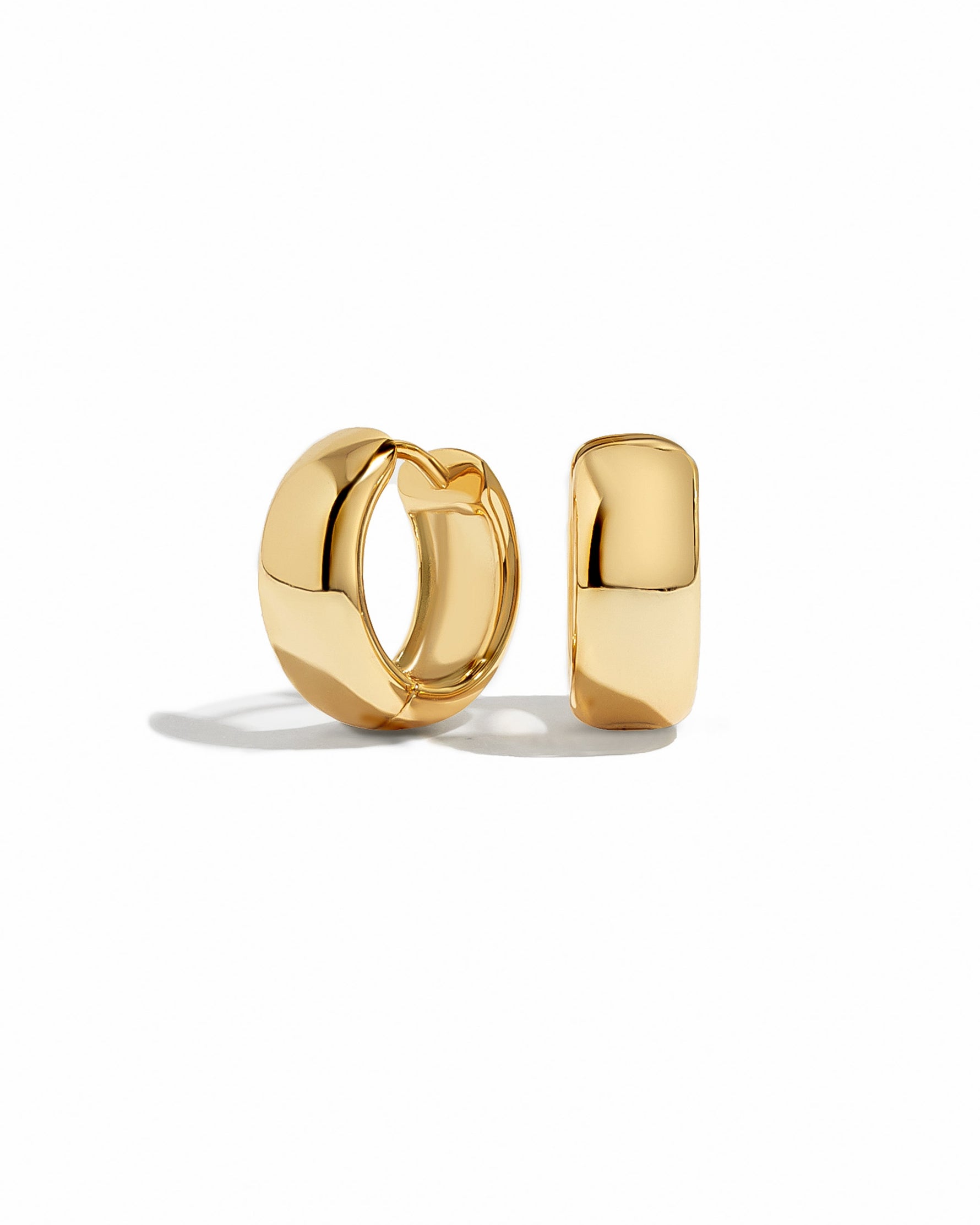 Gold hoop earrings on a white background