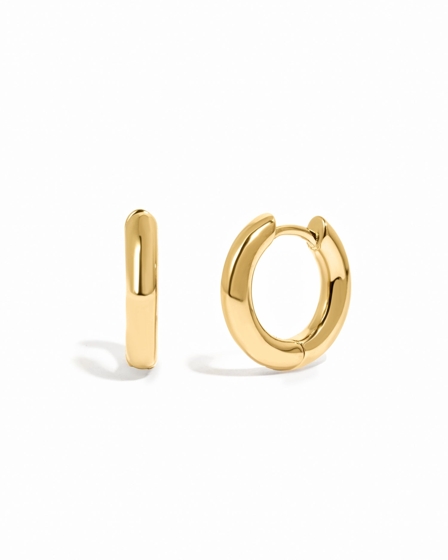 Gold small hoop earrings on a white background
