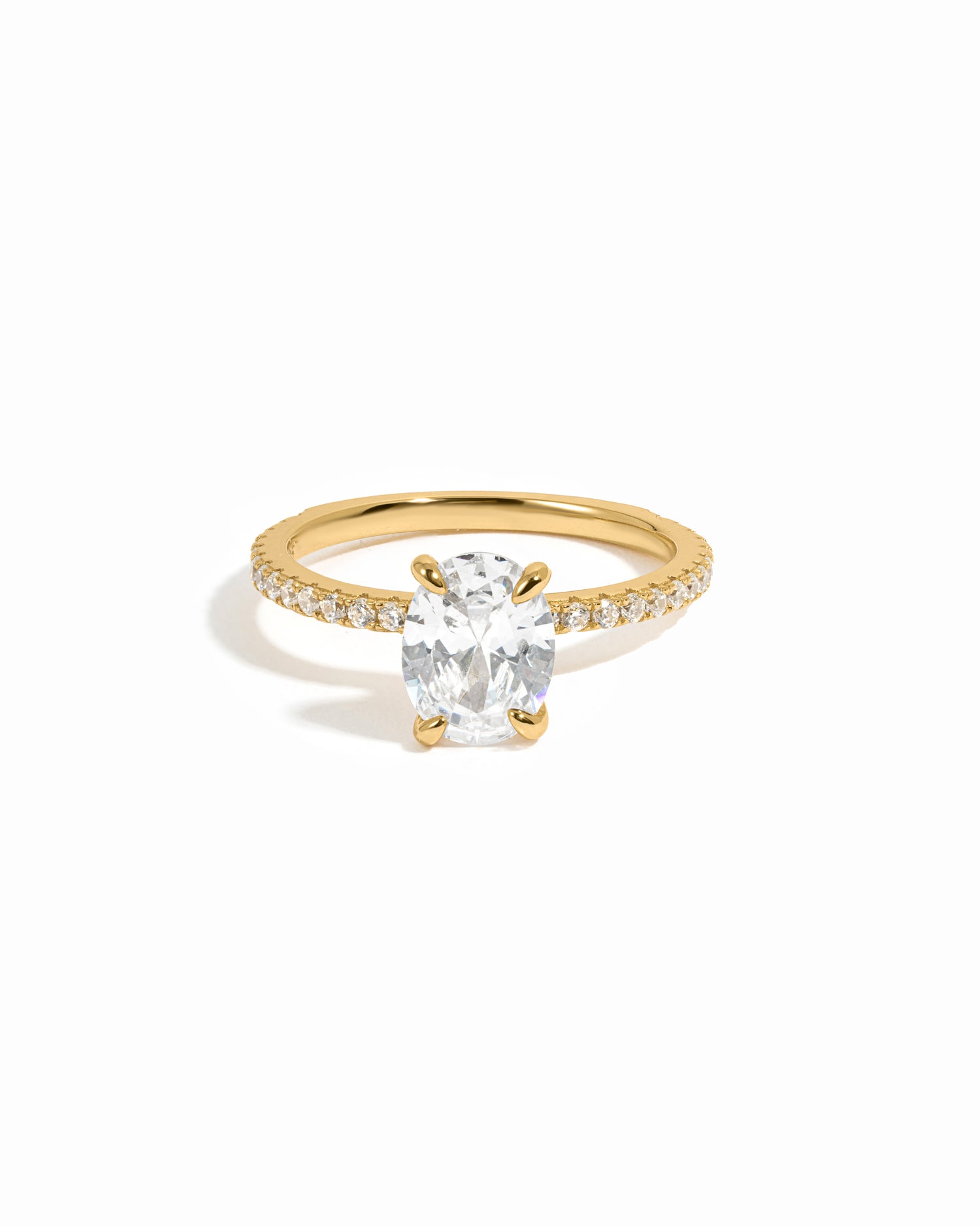 Gold engagement ring with diamond band on a white background