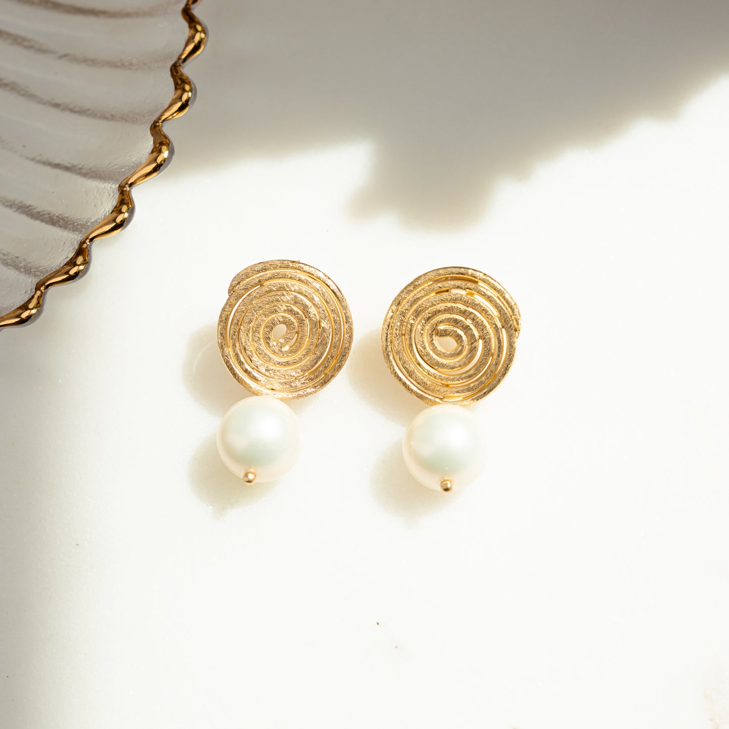 close-up image of boho earrings featuring spiral earring design