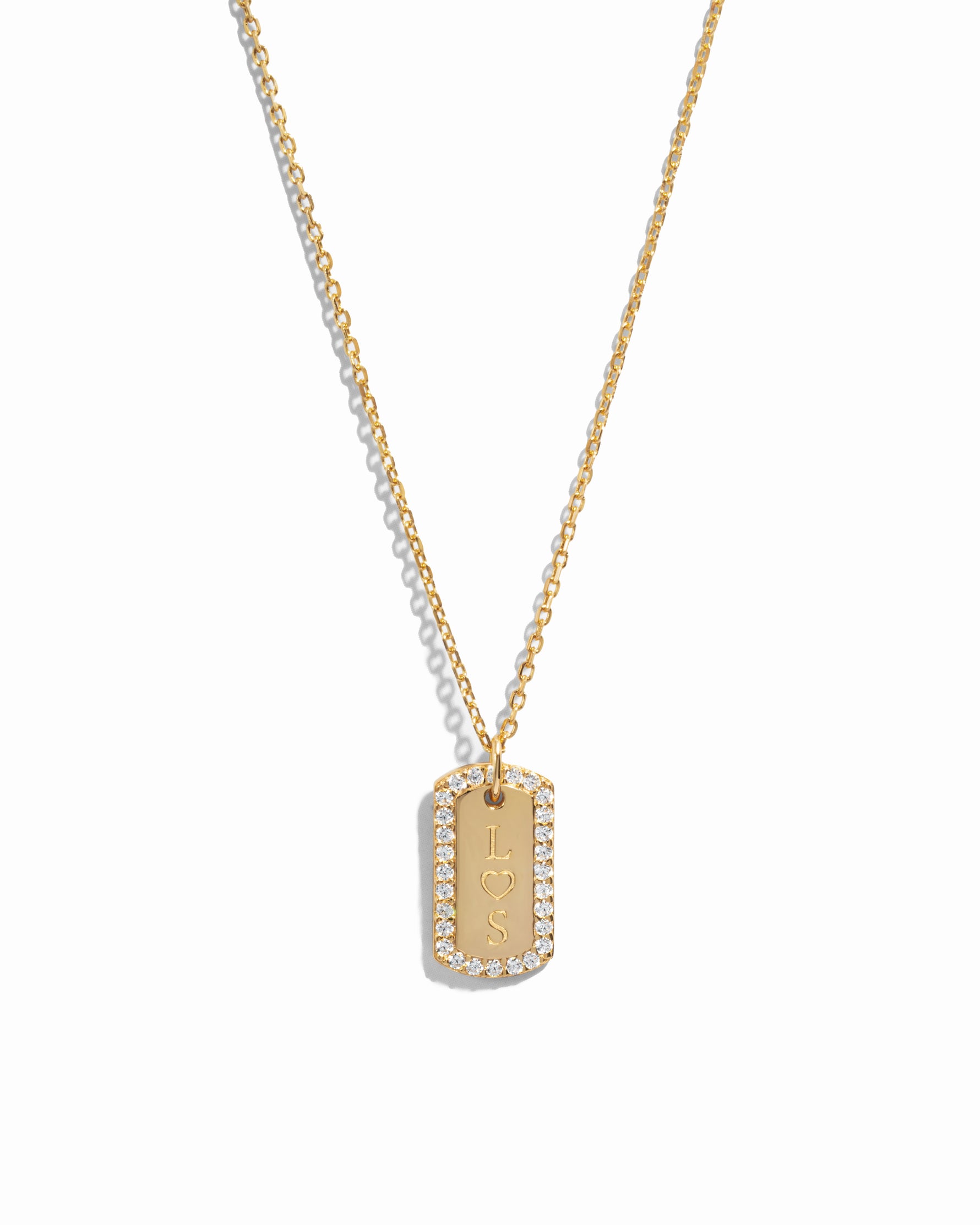 gold custom jewelry featuring a custom necklace with initials on pendant over a white background