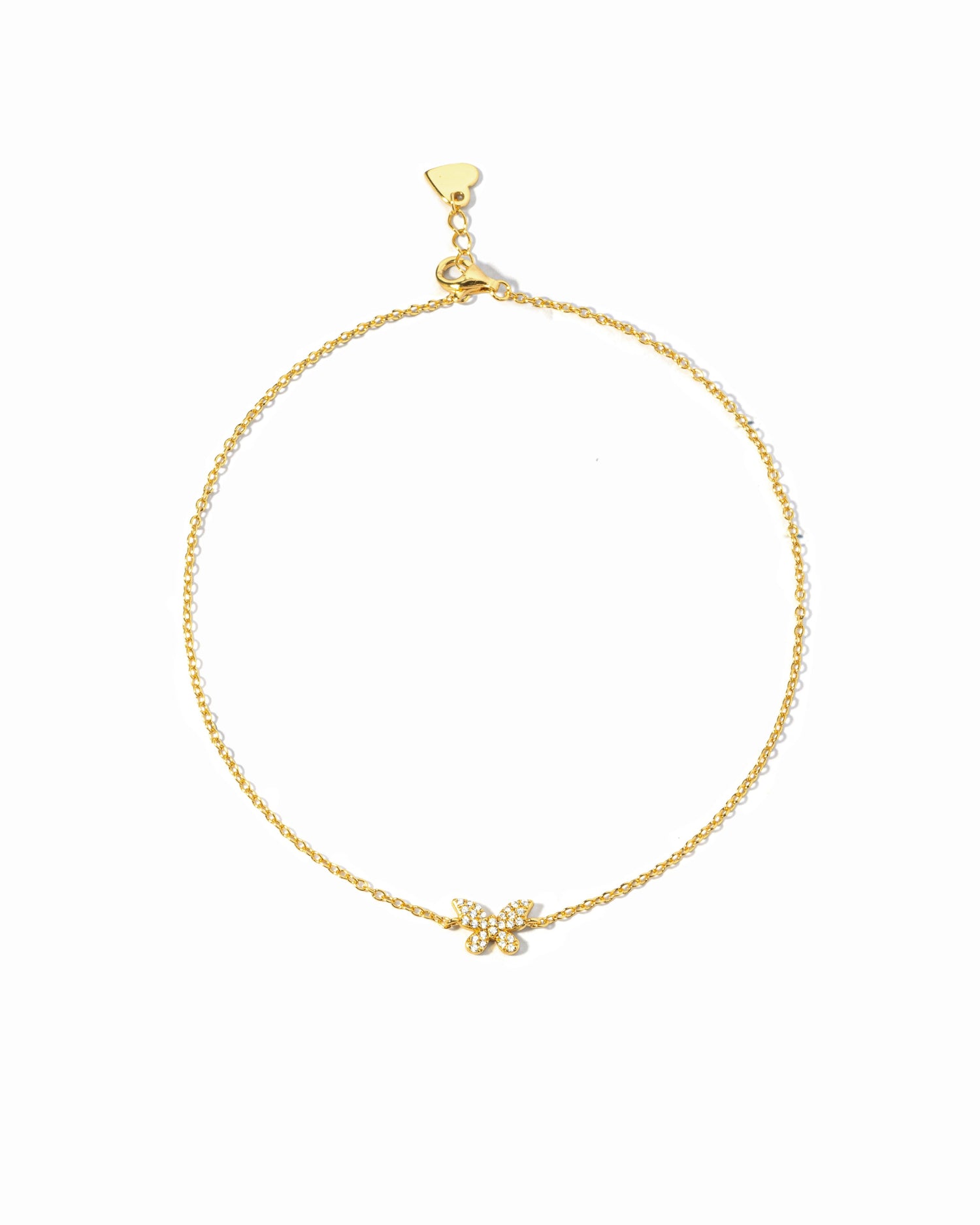 Gold bracelet with a small butterfly charm on a white background