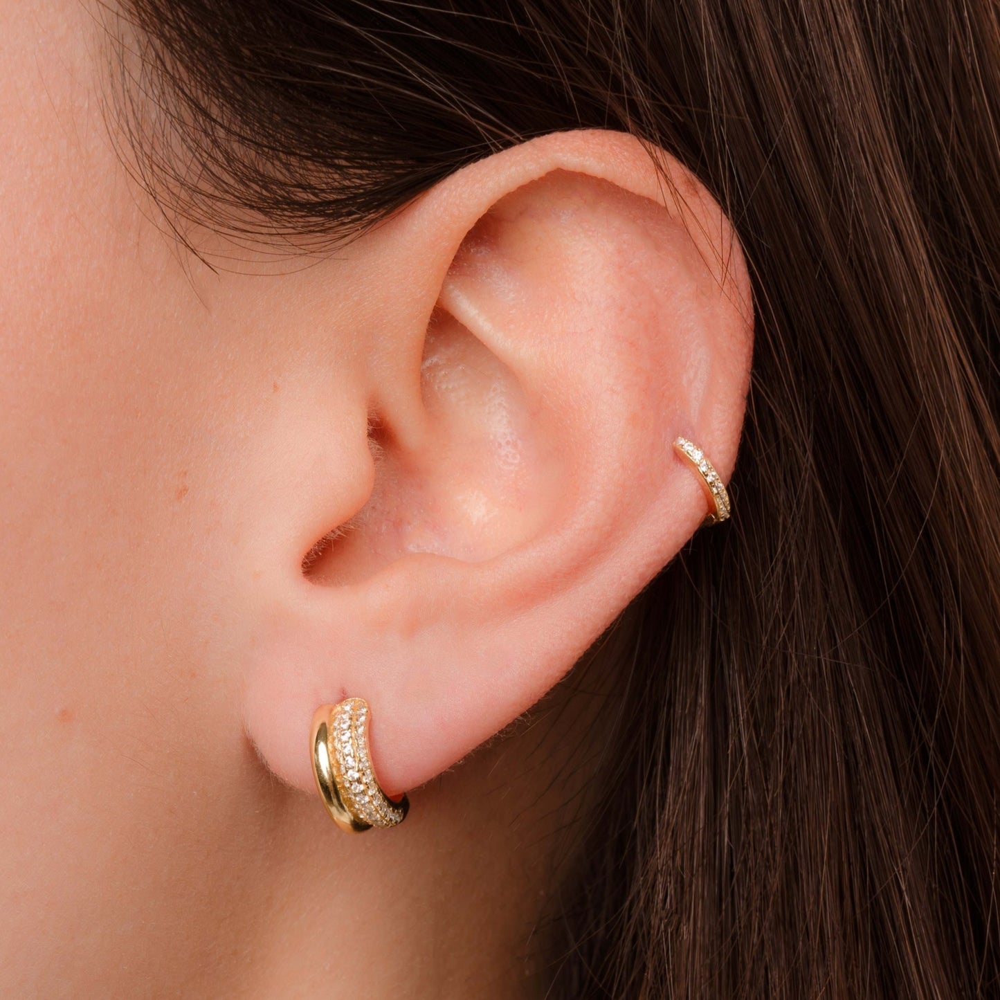 model wearing gold hoops featuring gold double hoop earrings