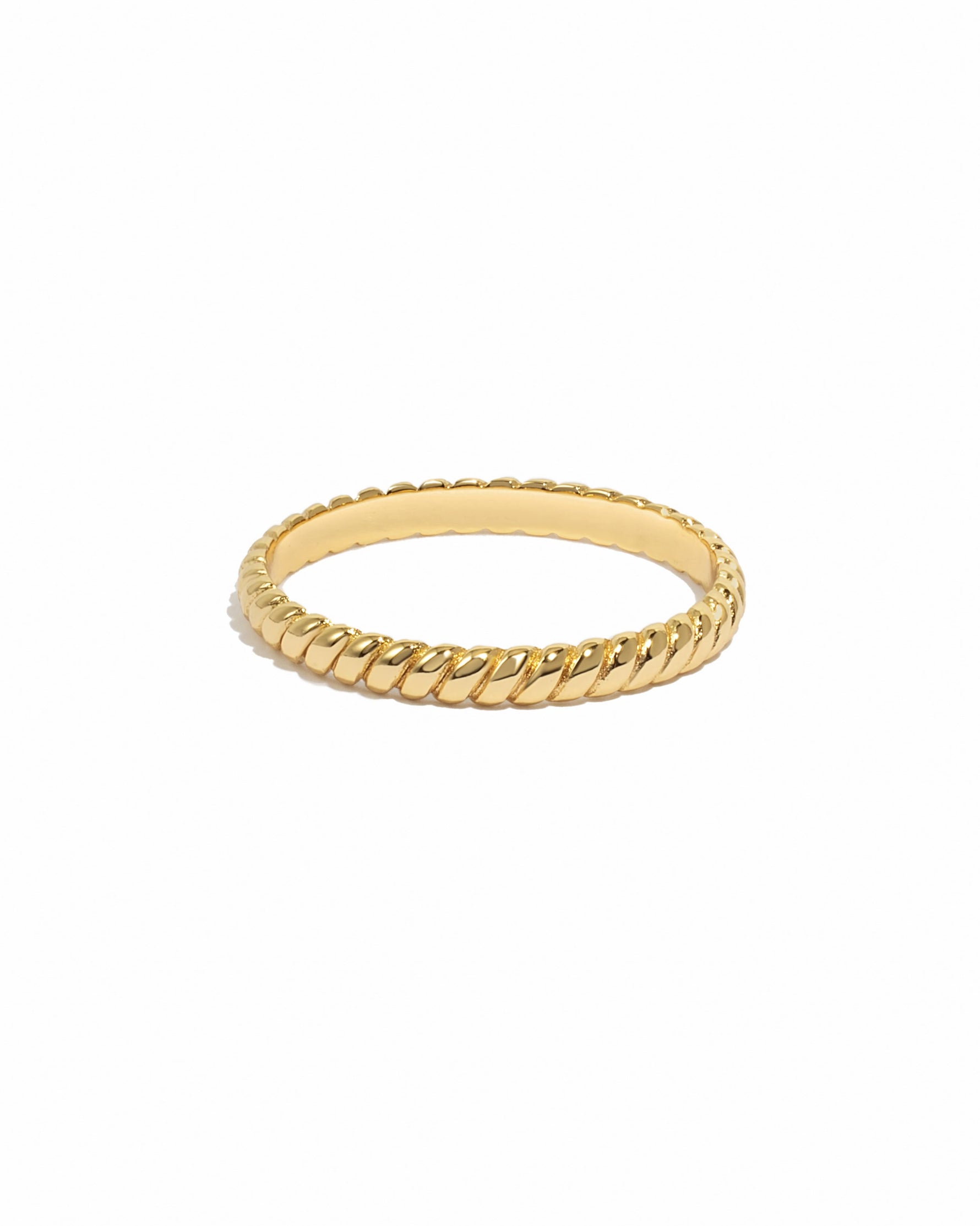 Gold ring with a textured band on a white background