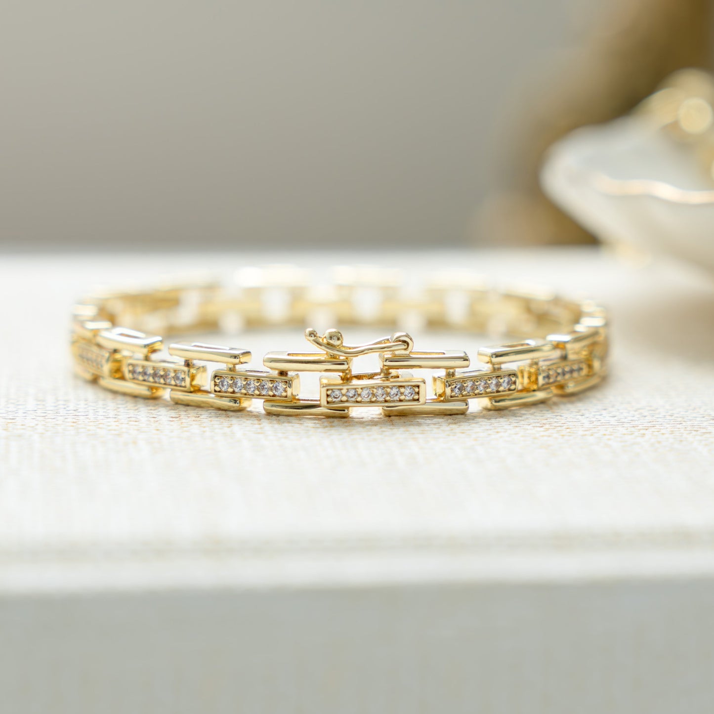 Closeup view of unique jewelry featuring a chunky gold chain link bracelet