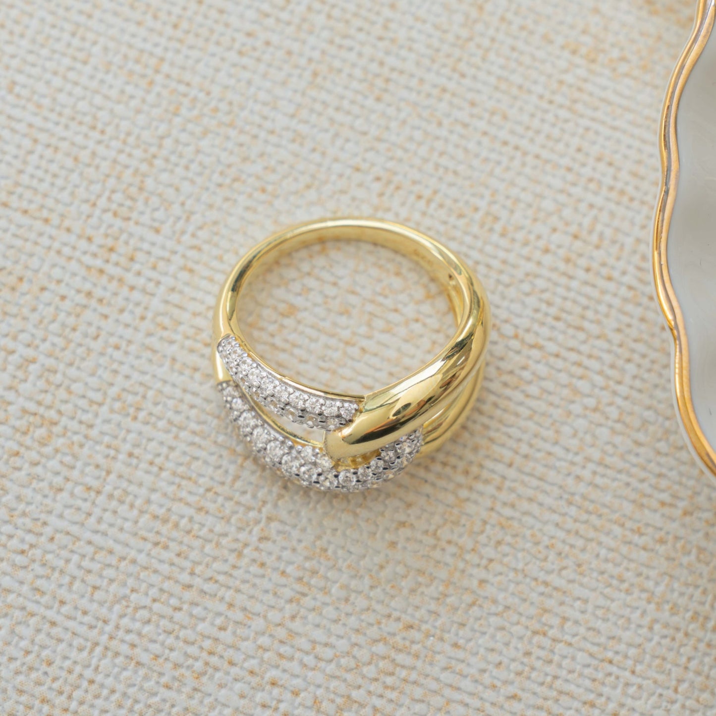 Closeup image of 14k gold plated infinity ring with two tone ring design