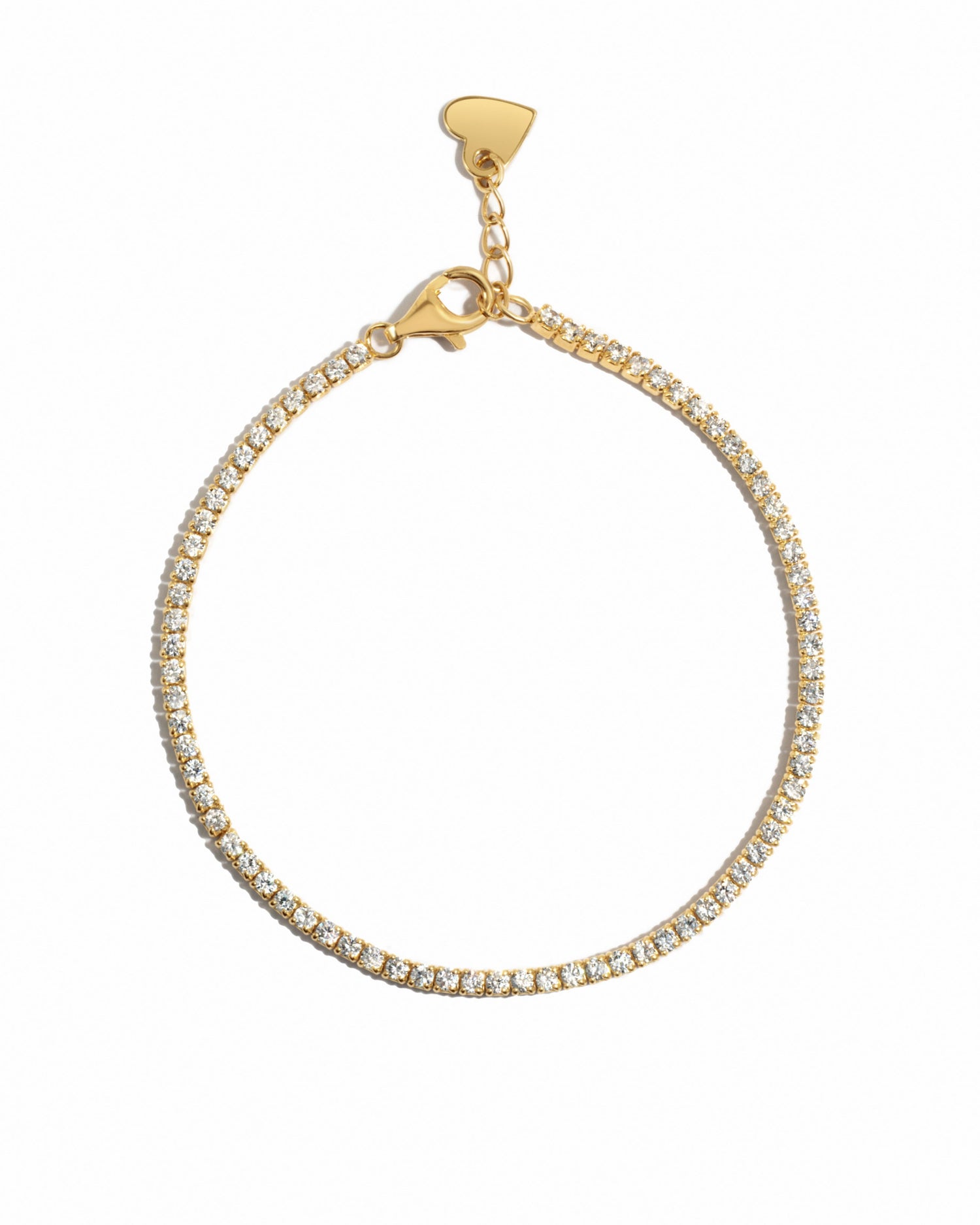 Delicate gold tennis bracelet on a white background