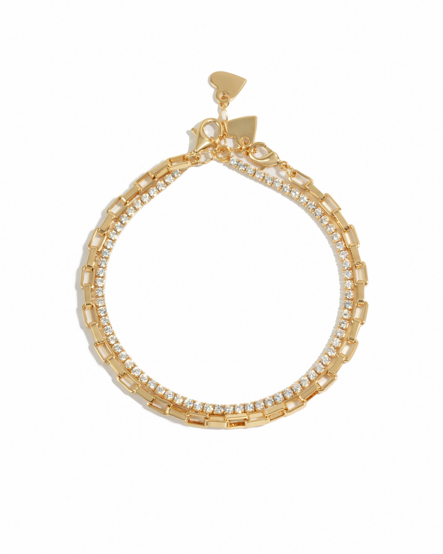Closeup image of gold tennis bracelet and dainty tiny paperclip chain bracelet, to be worn as a bracelet set on a white background