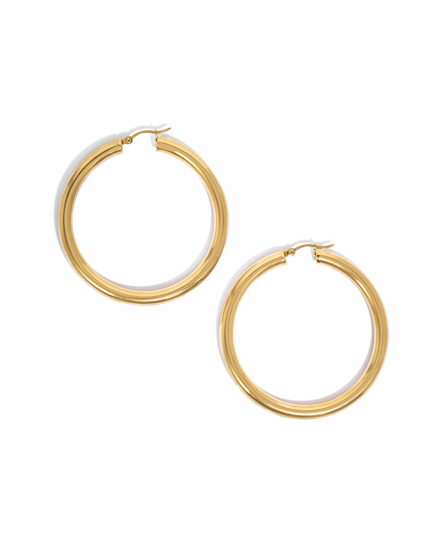 Gold chunky statement tube hoops.