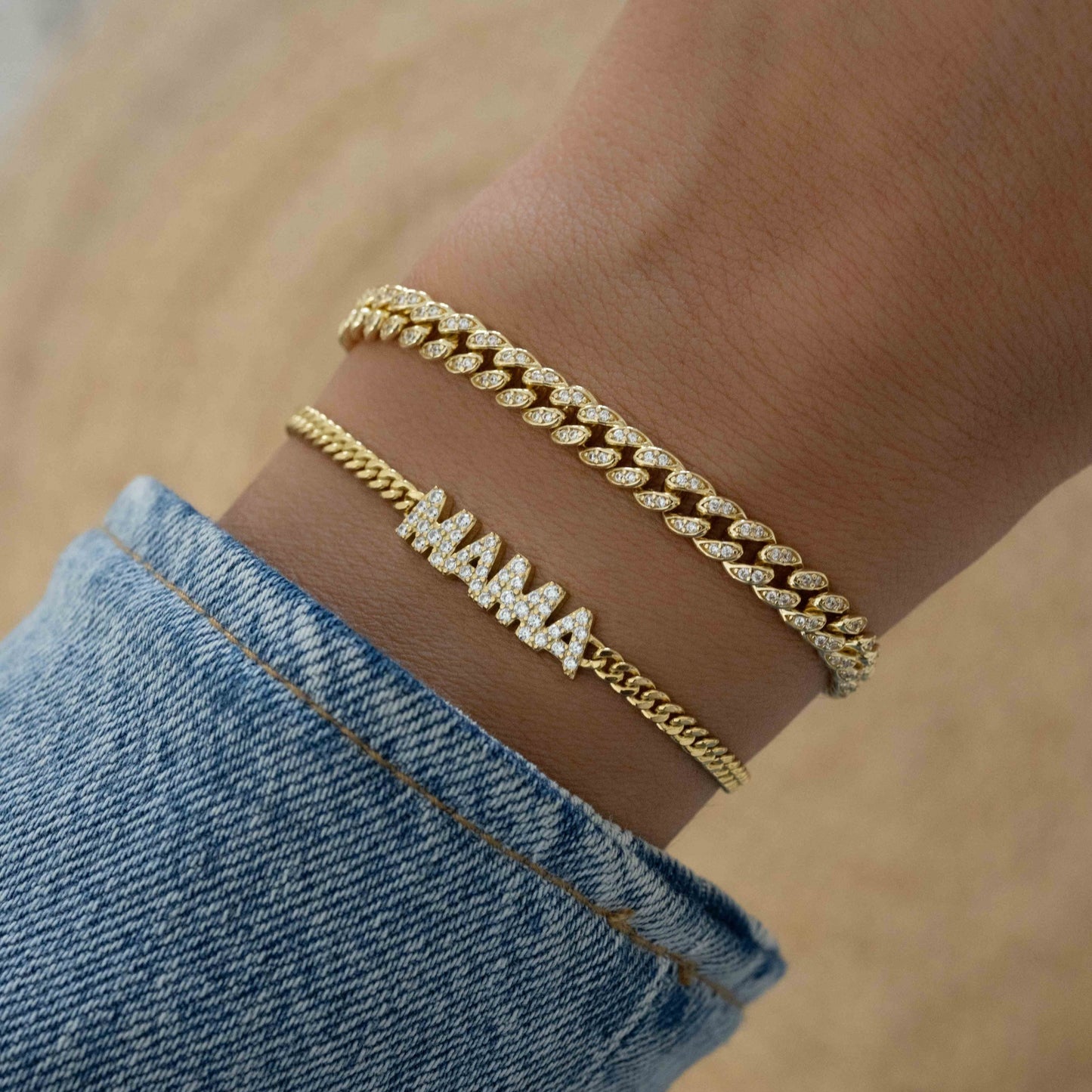 Model wearing gold statement jewelry featuring a gold chain with cuban link chain design and MAMA charm