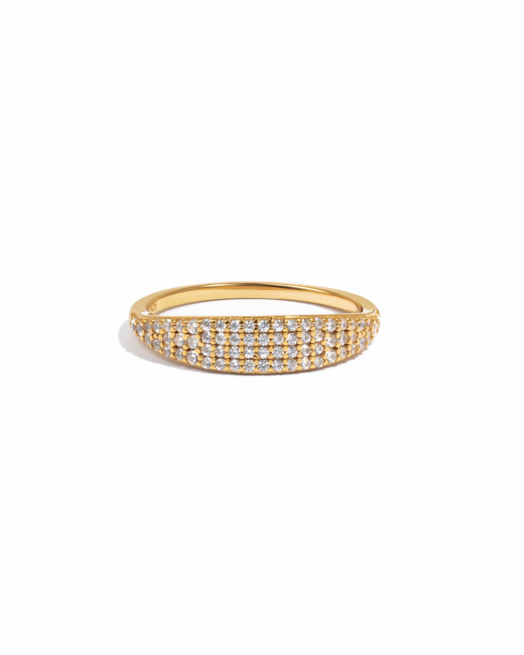 Gold signet ring with small pave diamonds on a white background