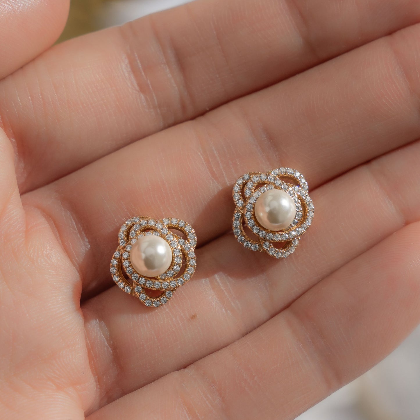 model showcasing wedding jewelry featuring pearl earring design and flower design on gold cz earring